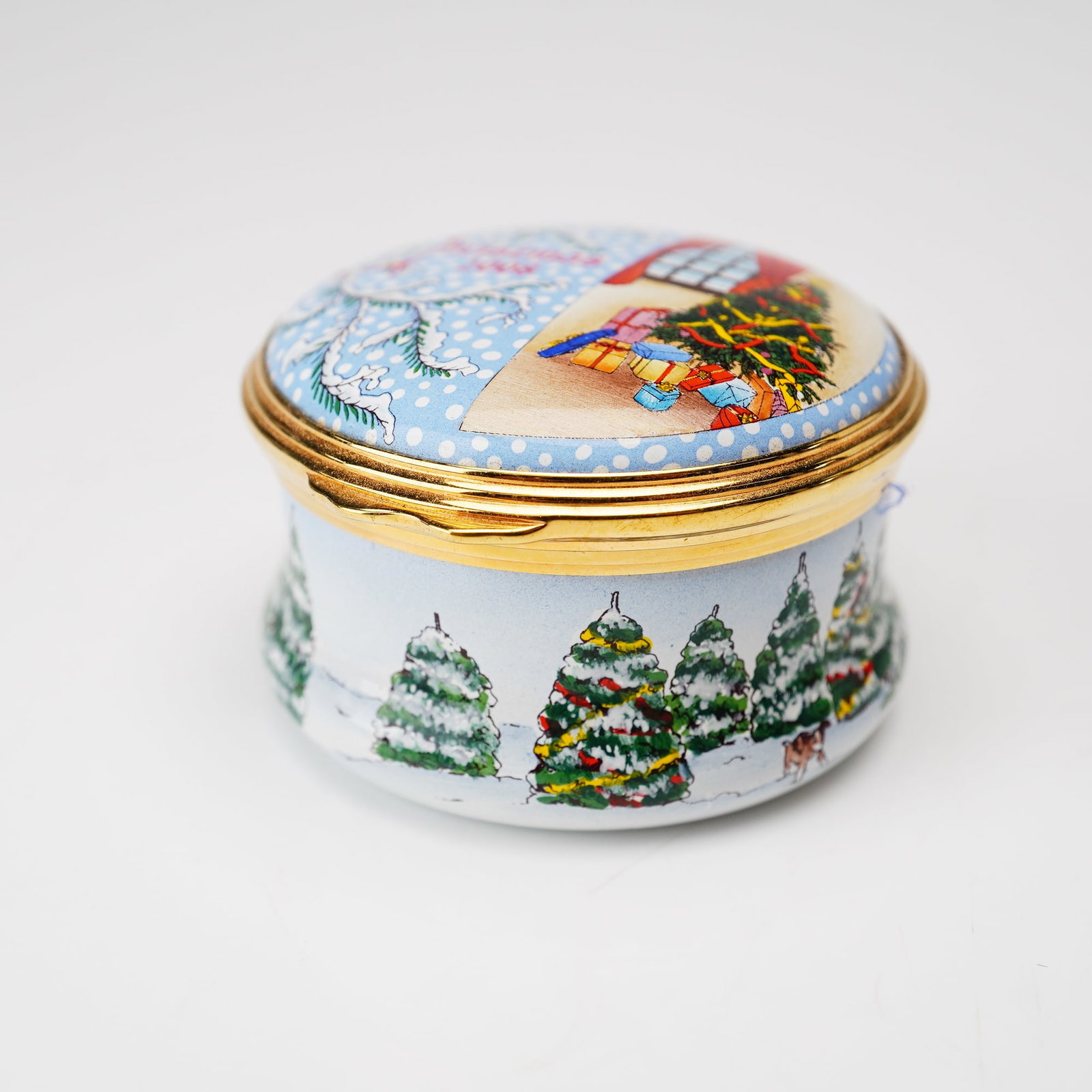 Halcyon Days English Enamel Treasure Box, Christmas 2008: This Halcyon Days English Enamel Christmas 2008 treasure box is a decorative hinged trinket box crafted from enamel on copper with gilded metal mounts. The circular lid features a split-scene holiday 