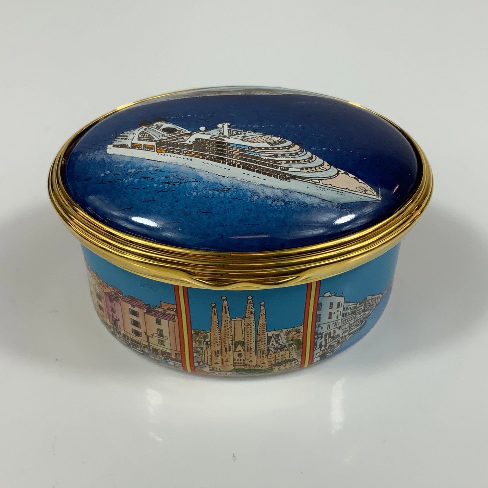 Halcyon Days St. James Place Limited Edition Enameled Treasure Box, Mediterranean Cruise 2016: This Halcyon Days enameled treasure box is a limited edition commemorative piece commissioned for St. James's Place Wealth Management. The oval box is constructed of copper with hand-painted enamel an