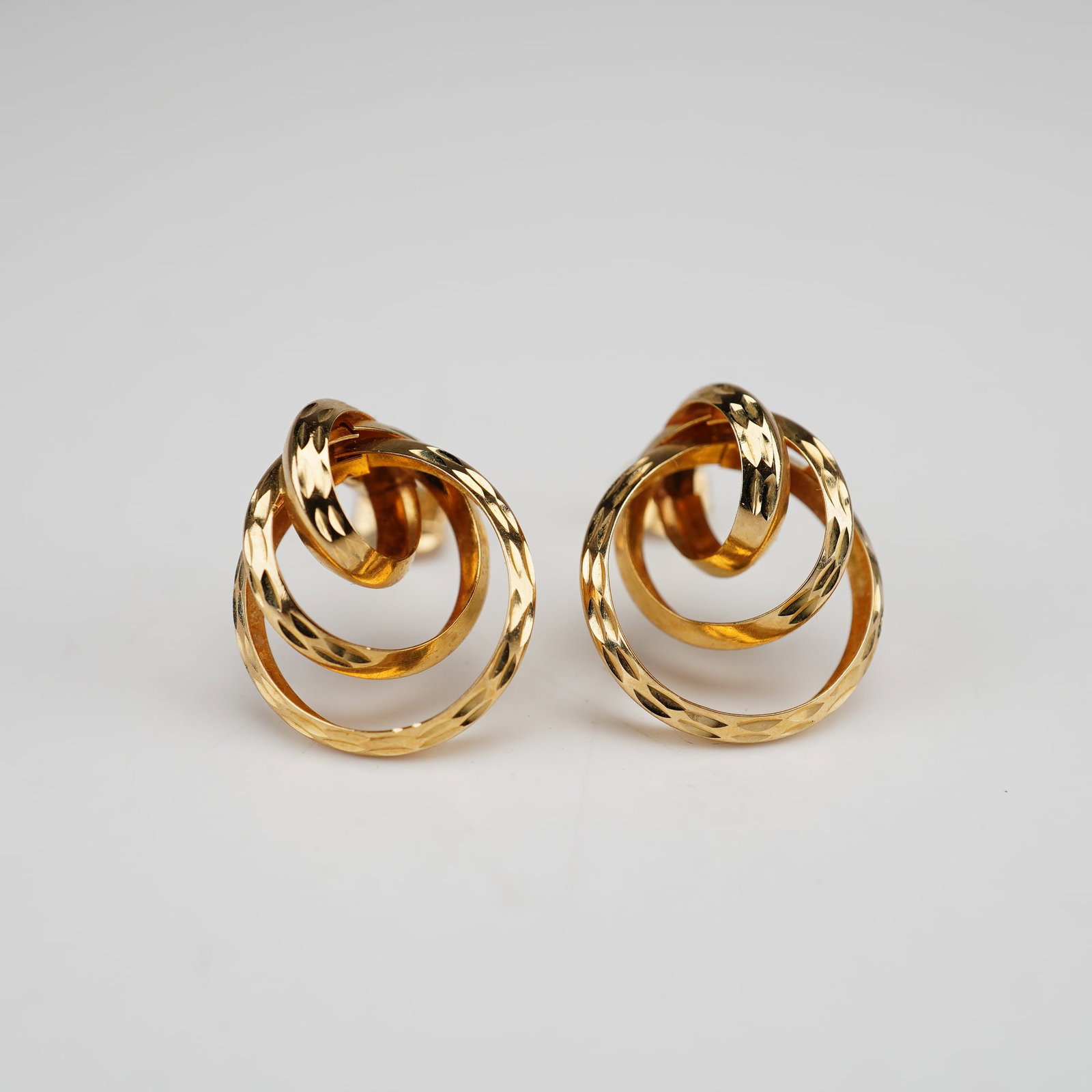 A Pair of CGI 14K Yellow Gold Interlocking Triple-Hoop Stud Earrings (1 of 4)