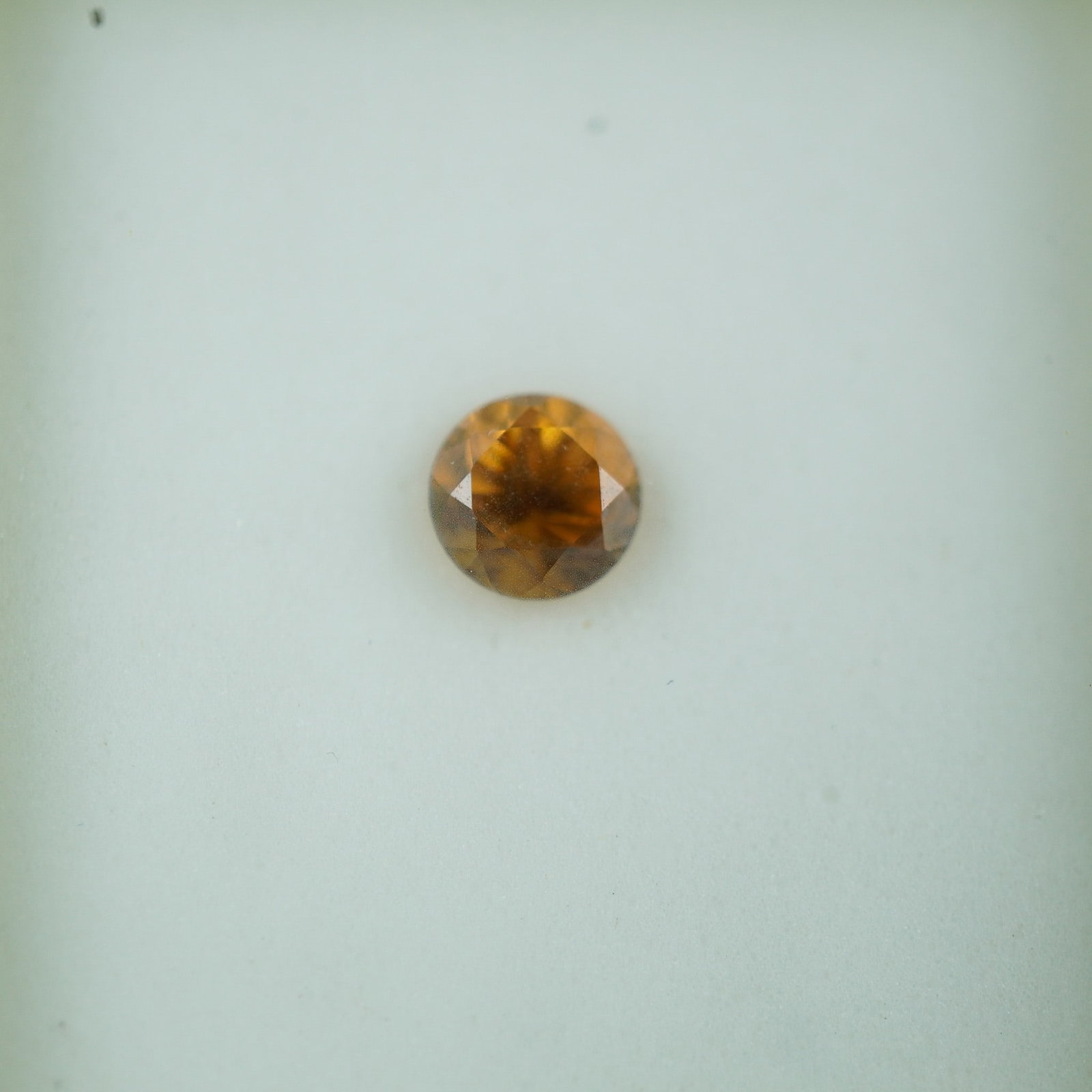 0.75 CT Honey Zircon Round Cut Gemstone: Brilliant round-cut honey zircon featuring a rich golden-brown hue with excellent luster and natural fire. Known for its high refractive index and strong dispersion, zircon offers diamond-like brillia