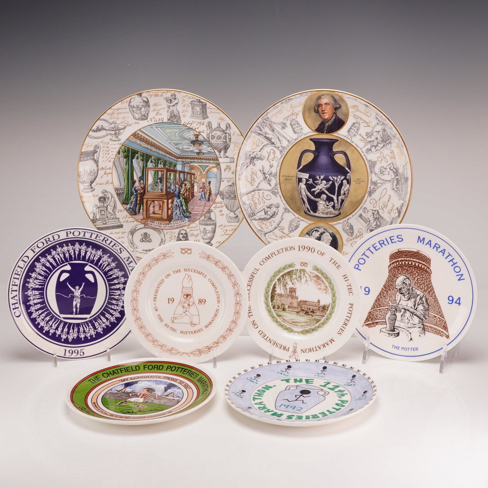 8pc Wedgwood Bone China Commemorative Plates: This collection consists of eight bone china commemorative plates manufactured by Wedgwood in England. The group includes six awards from the Potteries Marathon held in Stoke-on-Trent and two plates c