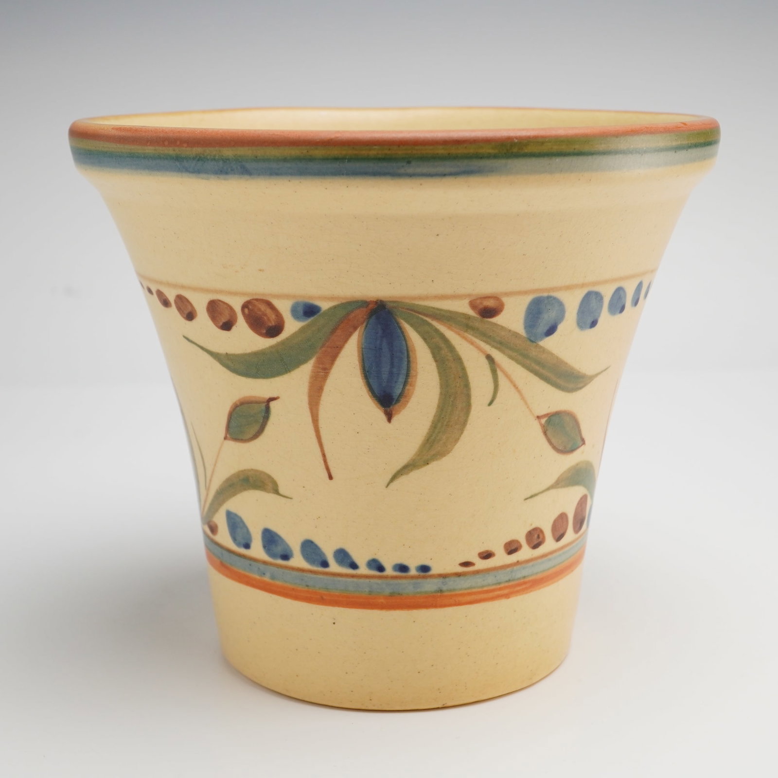Weller Pottery Bonito Pattern Jardiniere: A Weller Pottery jardiniere produced in the Bonito pattern, featuring a flared conical form with a wide, slightly everted rim. The earthenware body is finished in a matte cream-colored glaze and