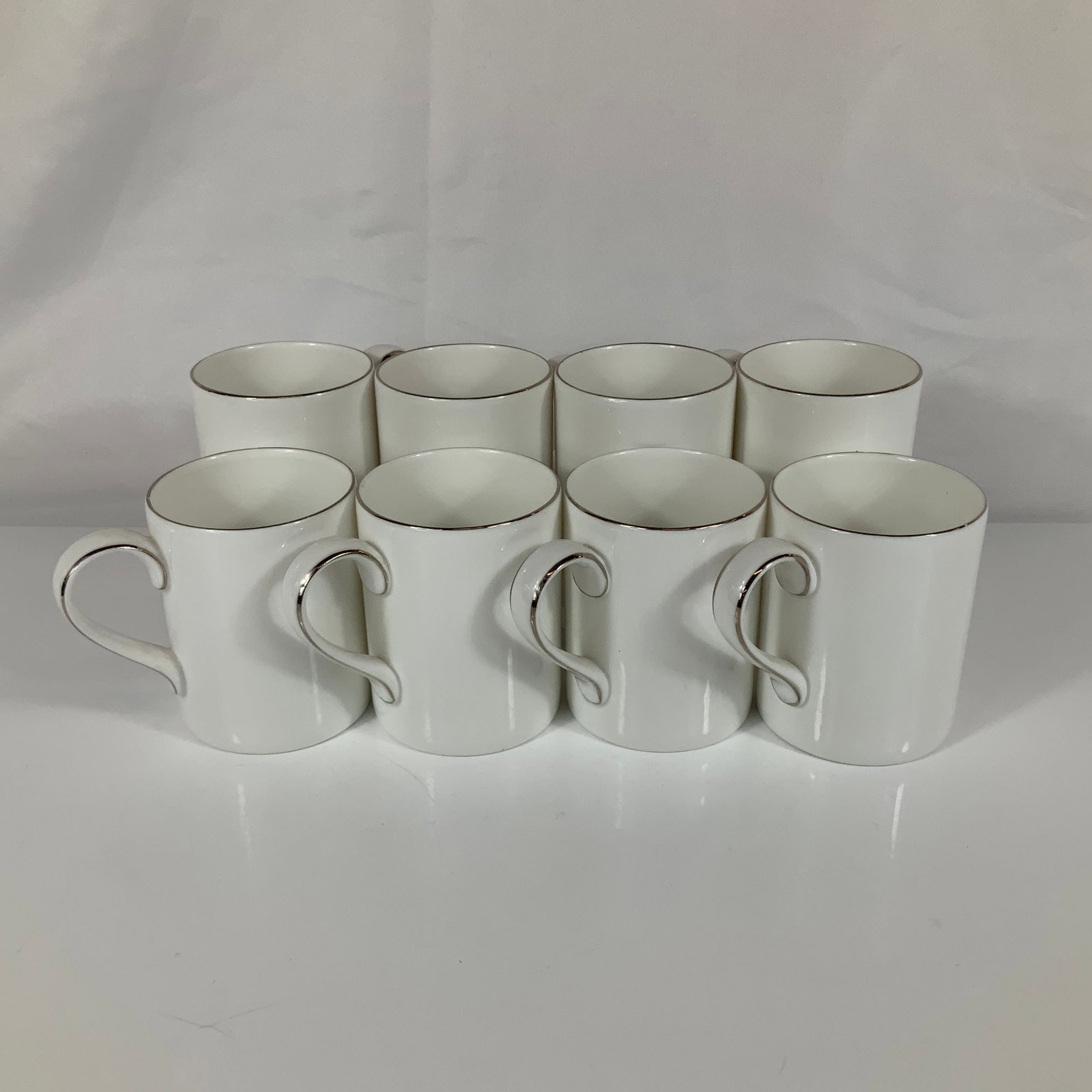 A Set of 8 Royal Doulton Classics Langdale Platinum H5289 Cups: This set of eight mugs is manufactured by Royal Doulton as part of the Classics collection in the Langdale Platinum pattern, designated by pattern number H 5289. Each piece is constructed from fine bo