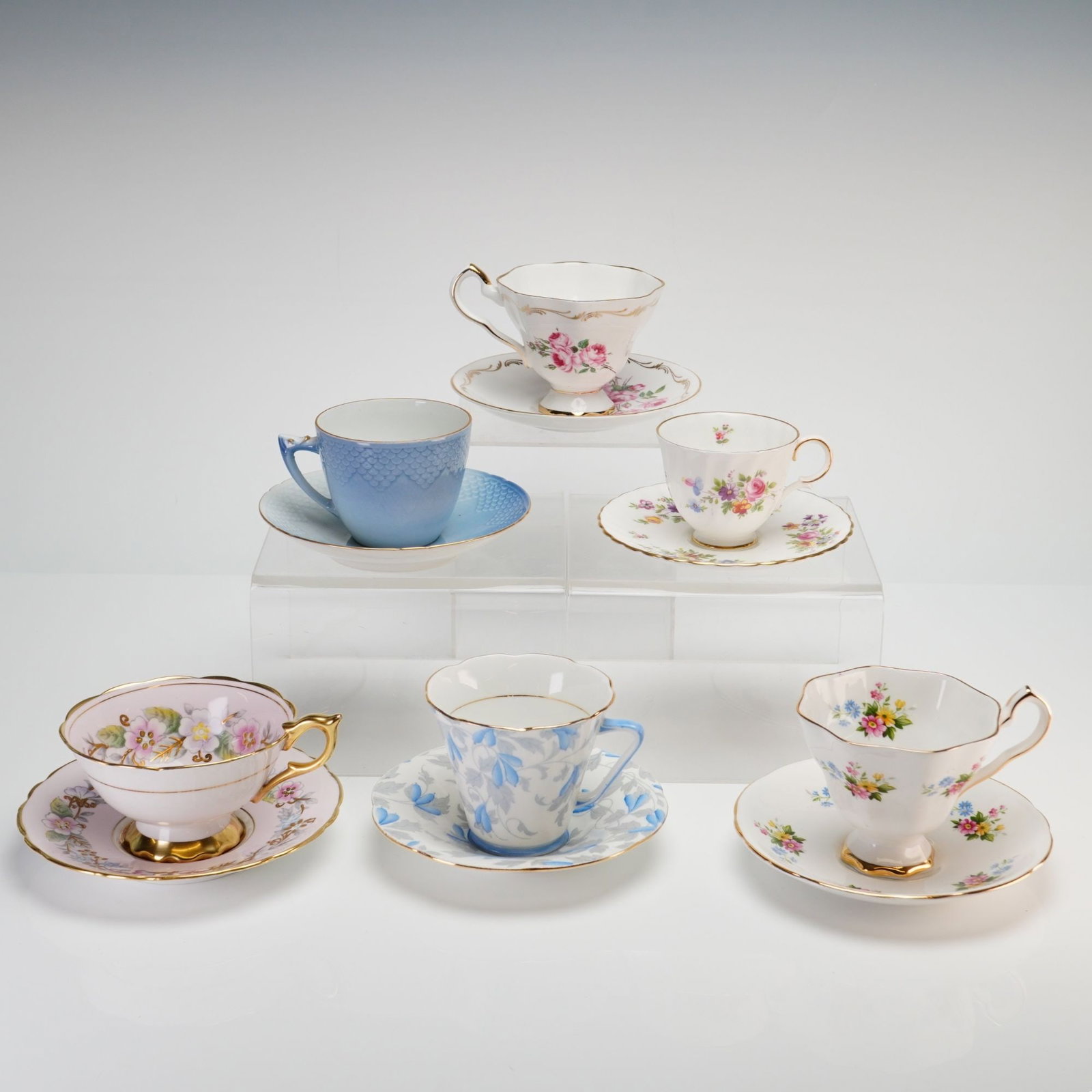 12pc English and Danish Bone China and Porcelain Teacups and Saucers: Collection consists of six teacup and saucer sets from various European manufacturers, including Royal Copenhagen, Minton, Royal Stafford, and Grafton. The Royal Copenhagen set is crafted from porcela