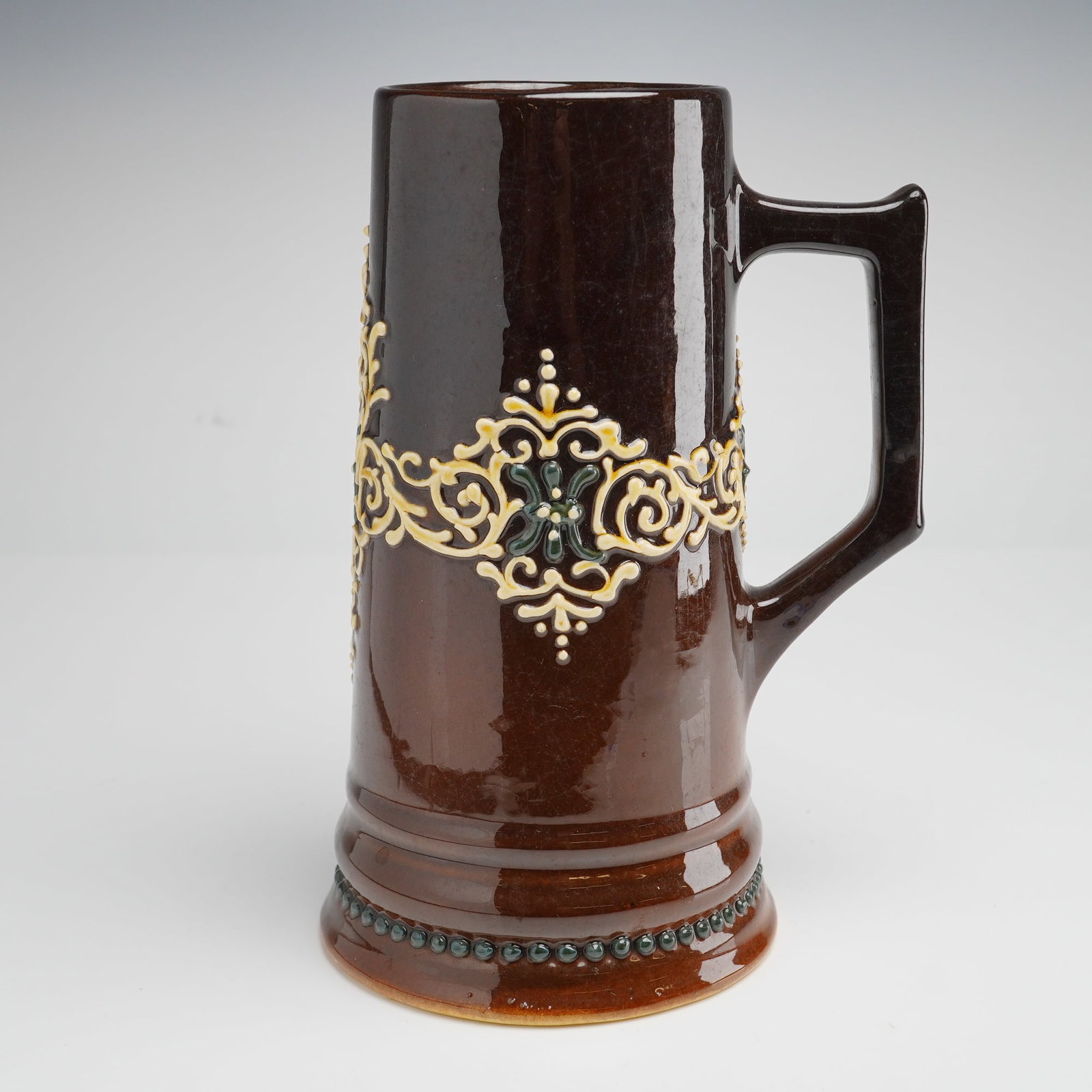 J.B. Owens Pottery Cyrano Brown Glazed Stein: This J.B. Owens Pottery Cyrano brown glazed stein is a sophisticated example of American art pottery from the Zanesville, Ohio, manufacturer, dating to the turn of the 20th century. The piece is
