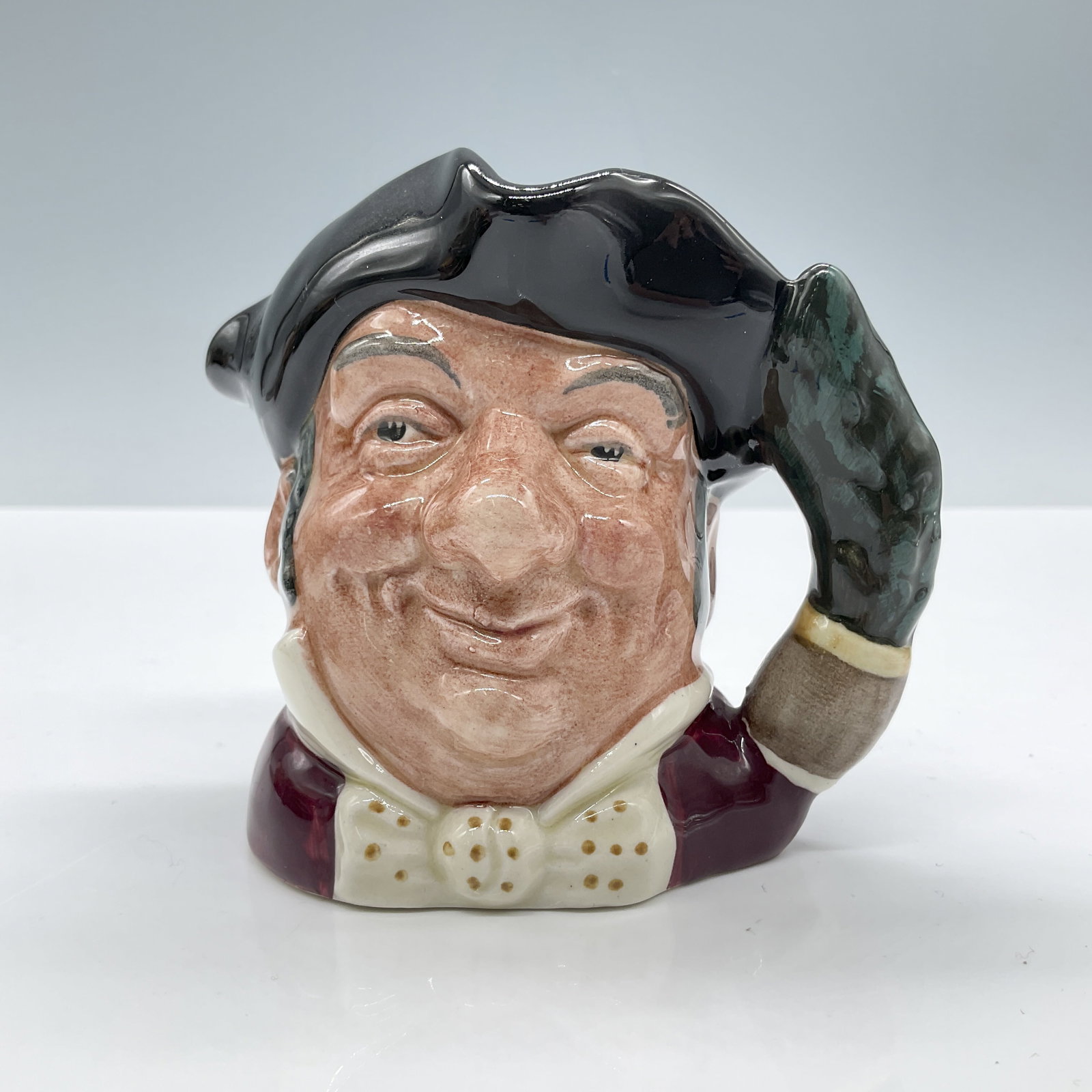 Mine Host D6470 - Small - Royal Doulton Character Jug: Black tricorn; red coat; white bow tie with gold spots. Royal Doulton backstamp. Artist: Max Henk Dimensions: 3.5"H Date or Era: 1958 - 1982 Manufacturer or Brand: Royal Doulton Country of Origin: