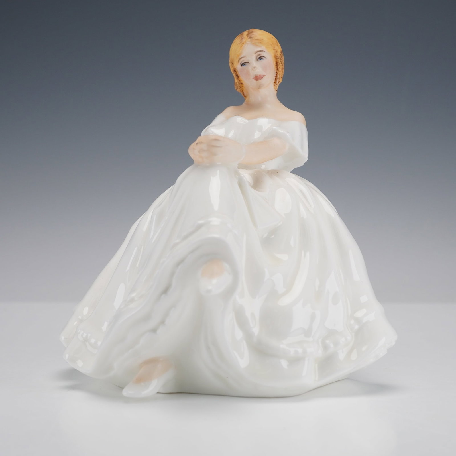 Royal Doulton Figurine, Heather HN2956: From the Vanity Fair Ladies series. Depicts a seated leady in a gorgeous white gown. Royal Doulton backstamp. Artist: Pauline Parsons Dimensions: 4.25"L x 5"W x 5.75"H Date or Era: 1982 - 2000 Manufac