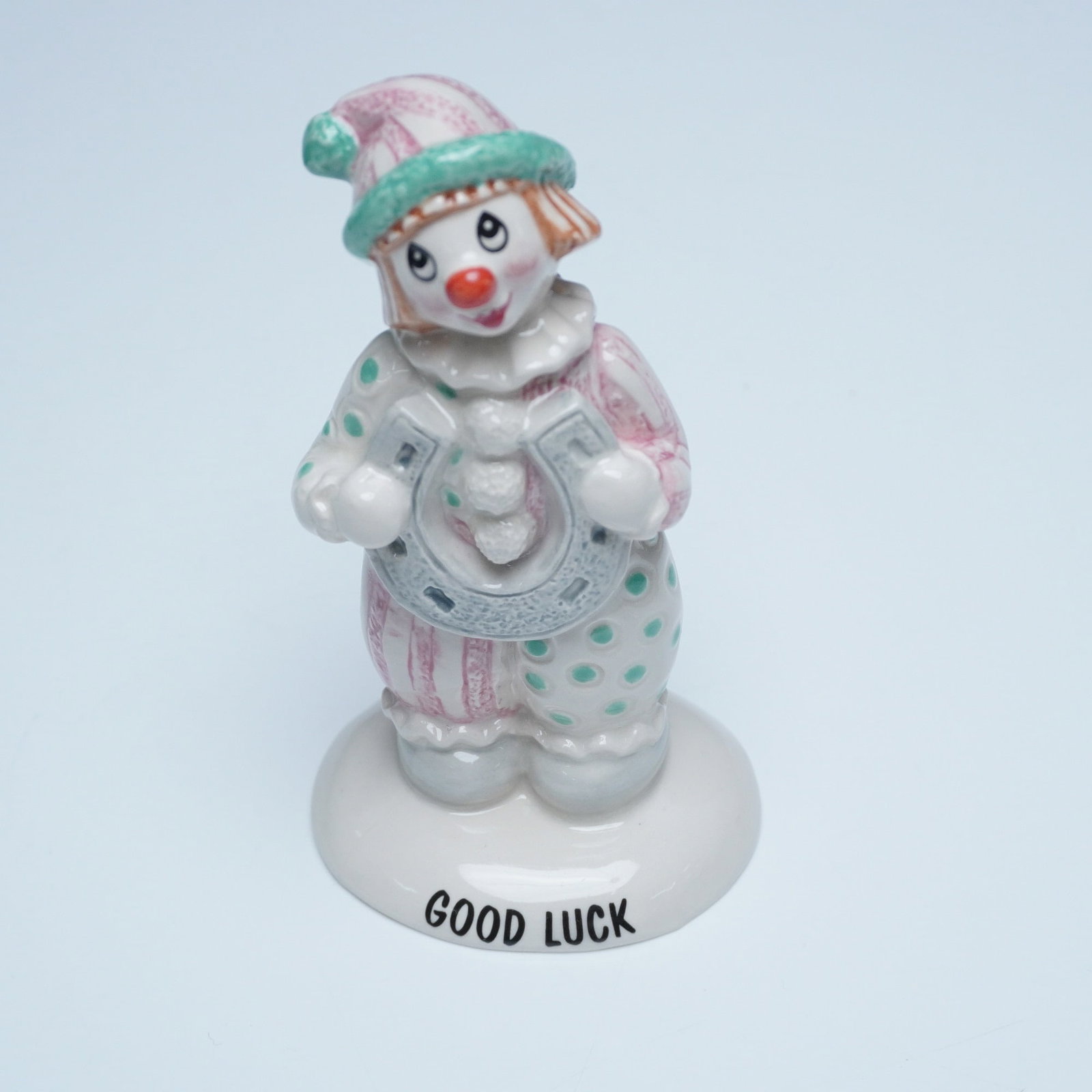 Beswick Little Lovables "Good Luck" Clown Figurine, LL31: A charming Beswick Little Lovables "Good Luck" clown figurine, model LL31. This hand-painted ceramic figure features a whimsical clown dressed in pastel pink and green polka-dotted attire, holding a l