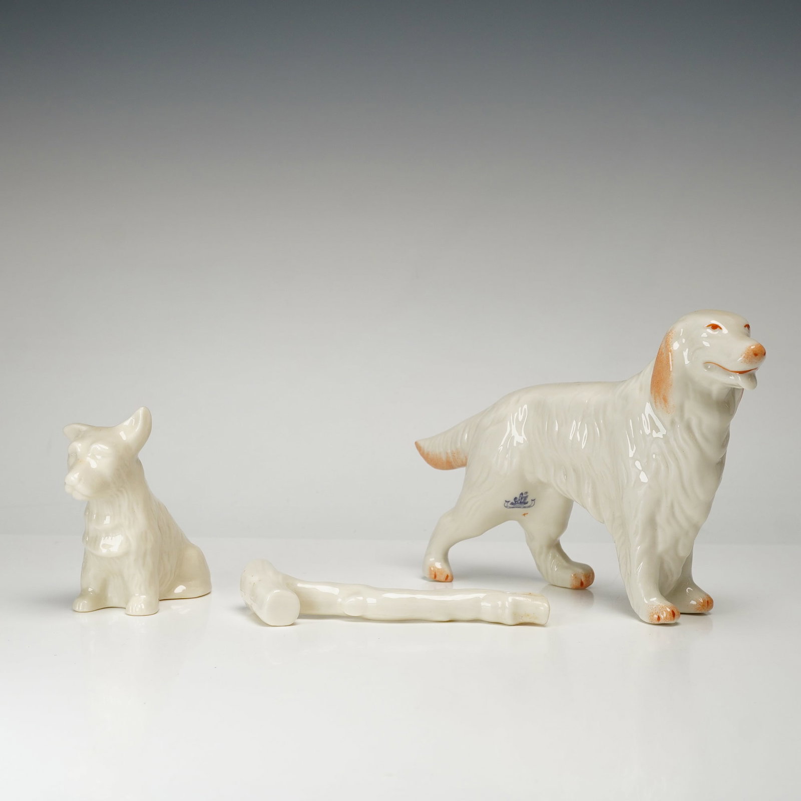 Belleek Parian Porcelain Irish Setter, Scottish Terrier Walking Stick Figurines: A group of three Belleek Parian porcelain items comprising two canine figures and one decorative accessory, walking stick. The collection includes a standing Irish Setter in a show pose, a small sitti