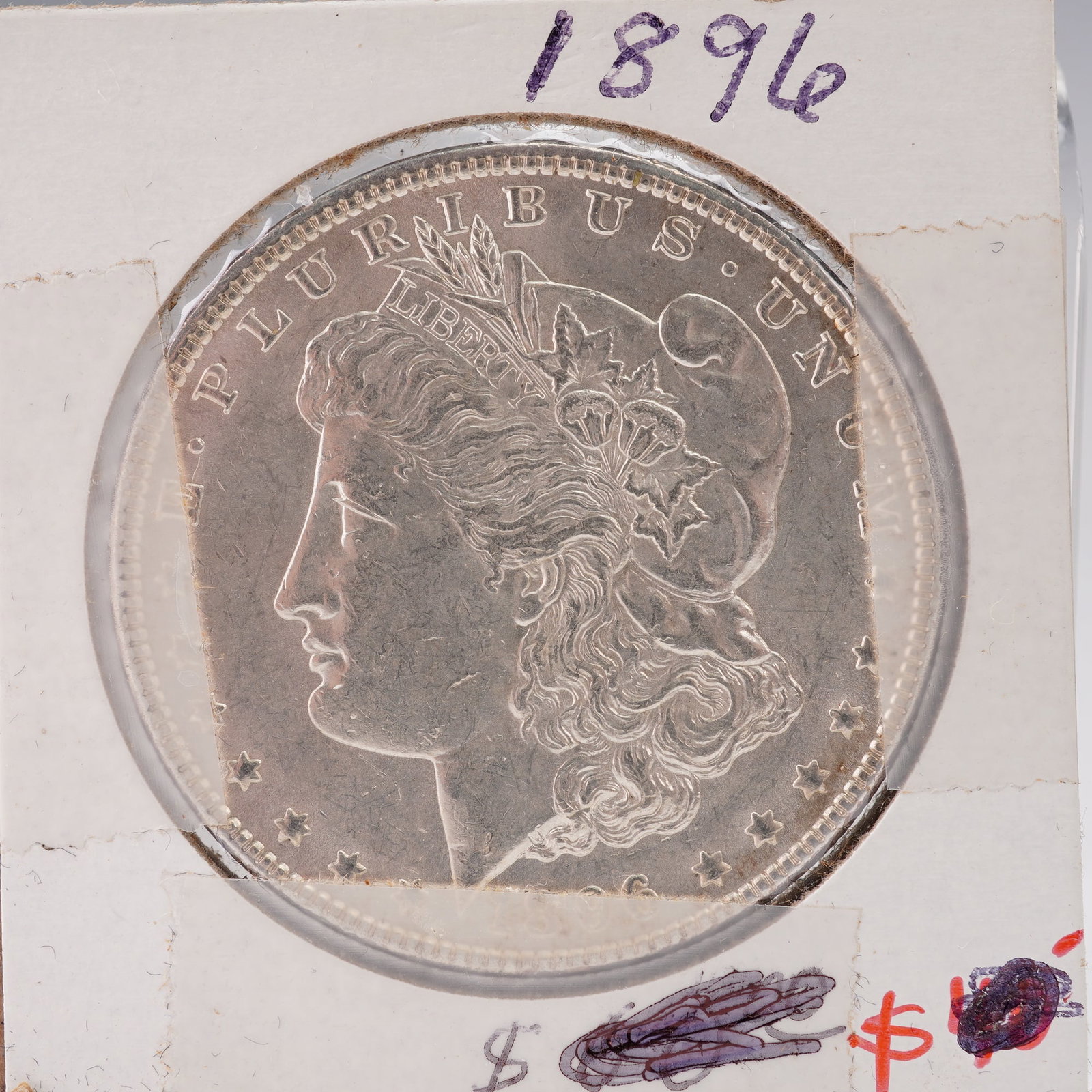 1896 Morgan Silver Dollar: An 1896 Morgan Silver Dollar featuring the classic design by George T. Morgan. The obverse shows Liberty wearing a Phrygian cap decorated with cotton and wheat, with E PLURIBUS UNUM and the year 1896 