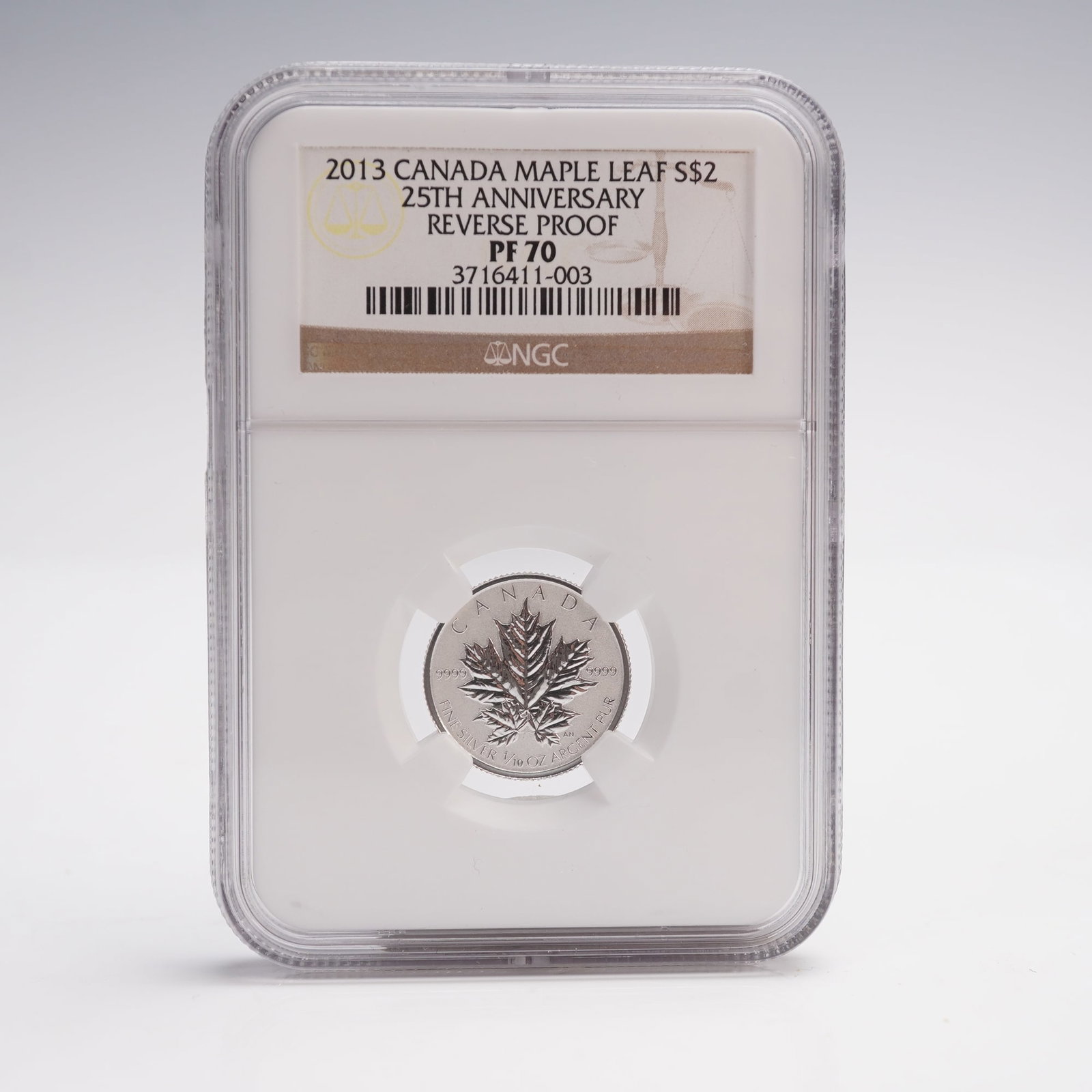 2013 Canada Maple Leaf 2 Dollar 25th Anniversary Coin NGC Graded PF-70: An anniversary silver coin struck in reverse proof finish. This commemorative piece contains 1/10 troy ounce of .9999 fine silver. The obverse features the effigy of Queen Elizabeth II with the dual d