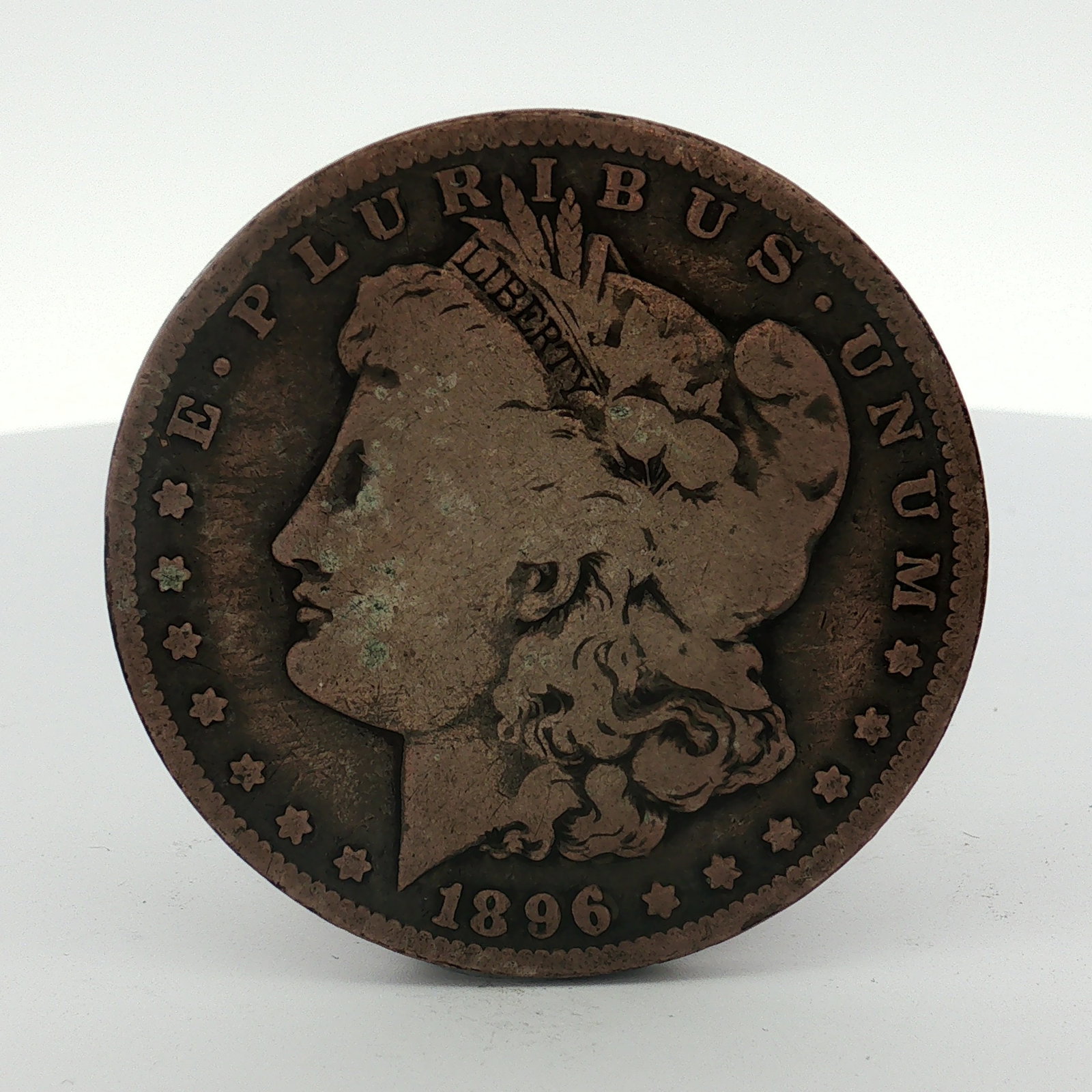 US 1896-O Morgan Silver Dollar: This US Morgan dollar was struck in 1896 at the New Orleans mint, as indicated by the O mint mark on the reverse. The coin is composed of 90% silver. It features the Morgan dollar obverse and reverse 