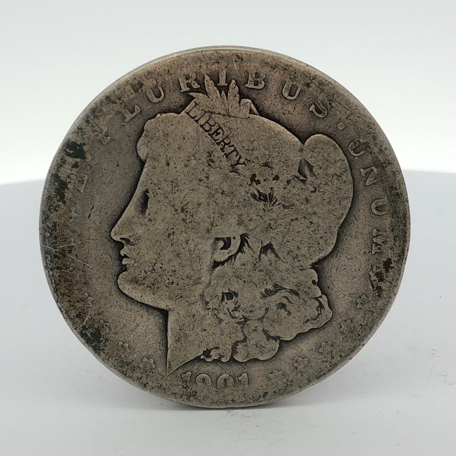 US 1901-O Morgan Silver Dollar: This US Morgan dollar was struck at the New Orleans Mint in 1901. The coin is composed of 90% silver and 10% copper. It features the Morgan dollar obverse and Morgan dollar reverse designs. A distinct