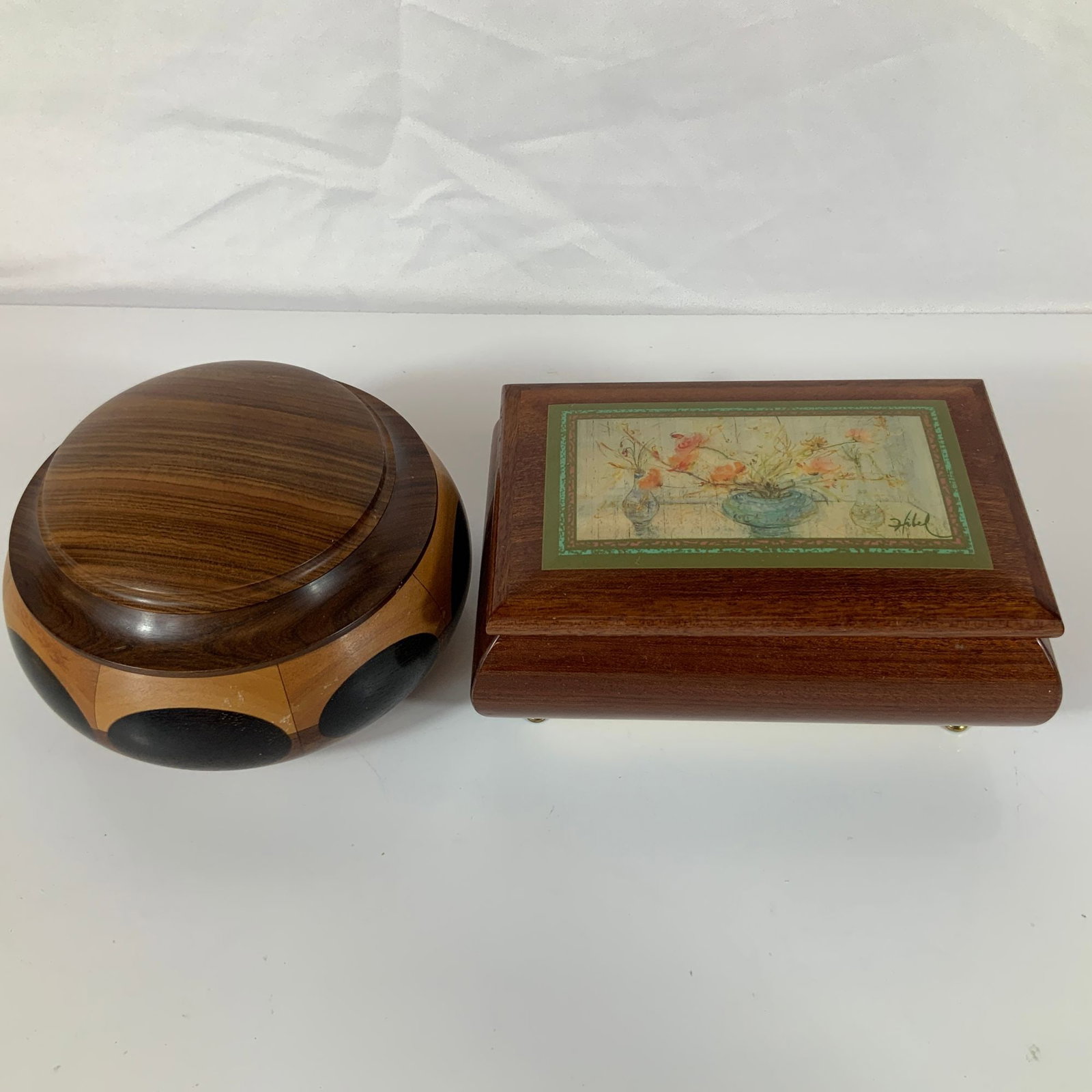 Two Carved Wood Jewelry Boxes Including One Italian Musical Box: This lot consists of two carved wood jewelry boxes. The first is a rectangular musical jewelry box featuring a dark, highly polished wood grain. The hinged lid is inset with a floral still life of pop