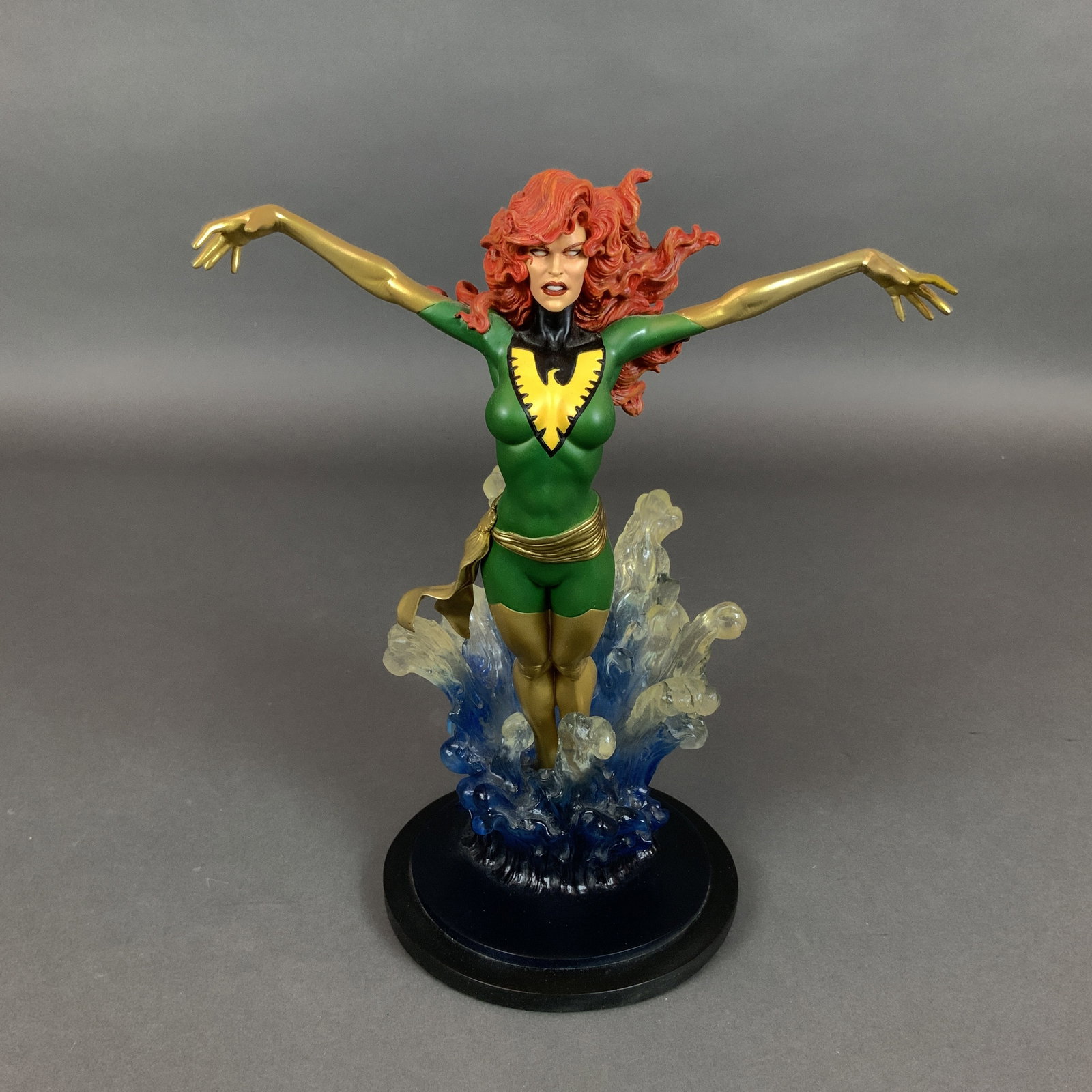 Bowen Designs Marvel Phoenix Painted Statue Sculpted by Mark Newman: A hand-painted resin collectible statue of the Marvel Comics character Phoenix (Jean Grey) produced by Bowen Designs, Inc. and sculpted by artist Mark Newman. The figure is depicted in her classic gre