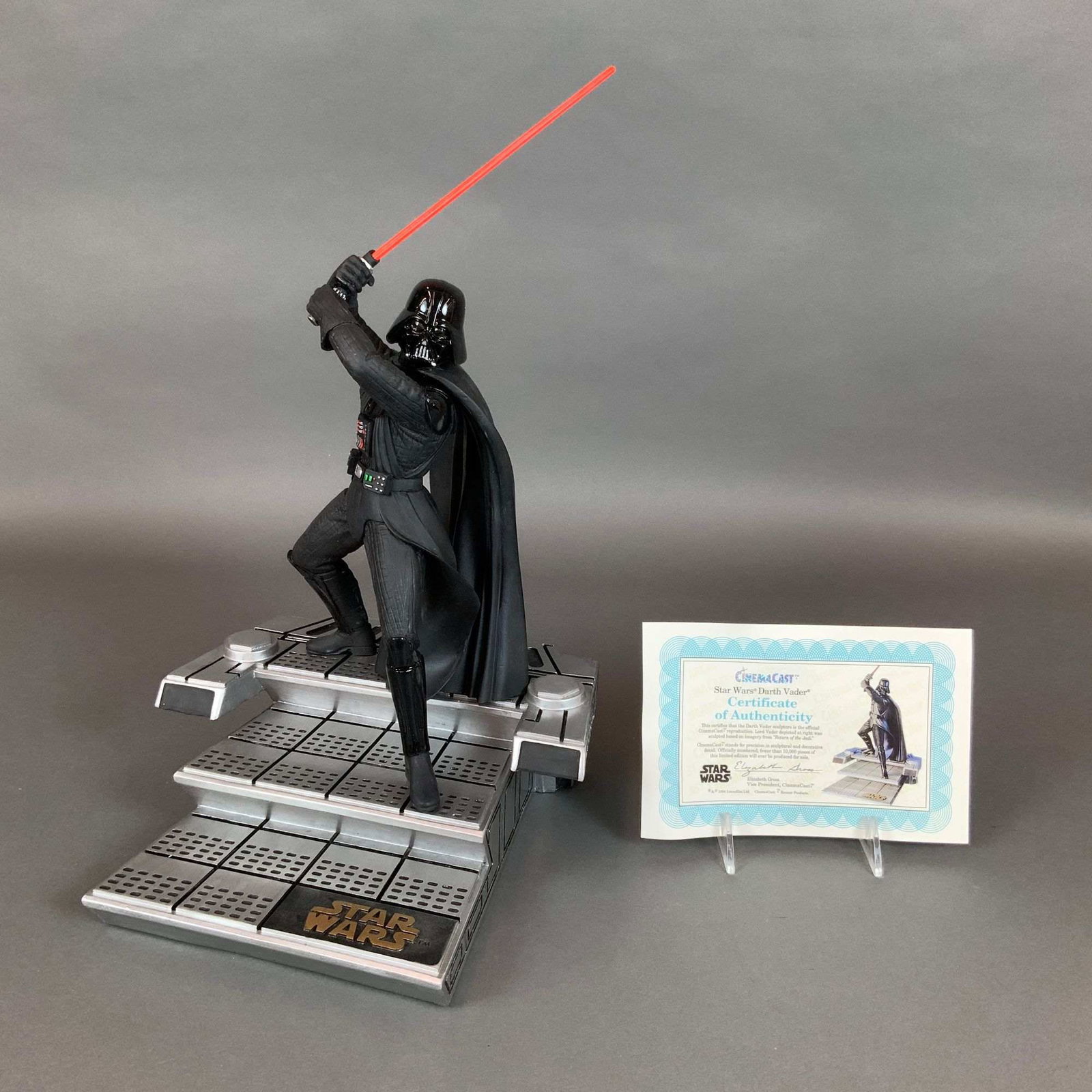 Kenner CinemaCast Star Wars Darth Vader Large Sculpture Limited Edition: This 1994 Kenner CinemaCast Star Wars Darth Vader large sculpture is a limited edition collectible. The piece depicts the character in a dynamic lunging pose, holding a translucent red lightsaber blad