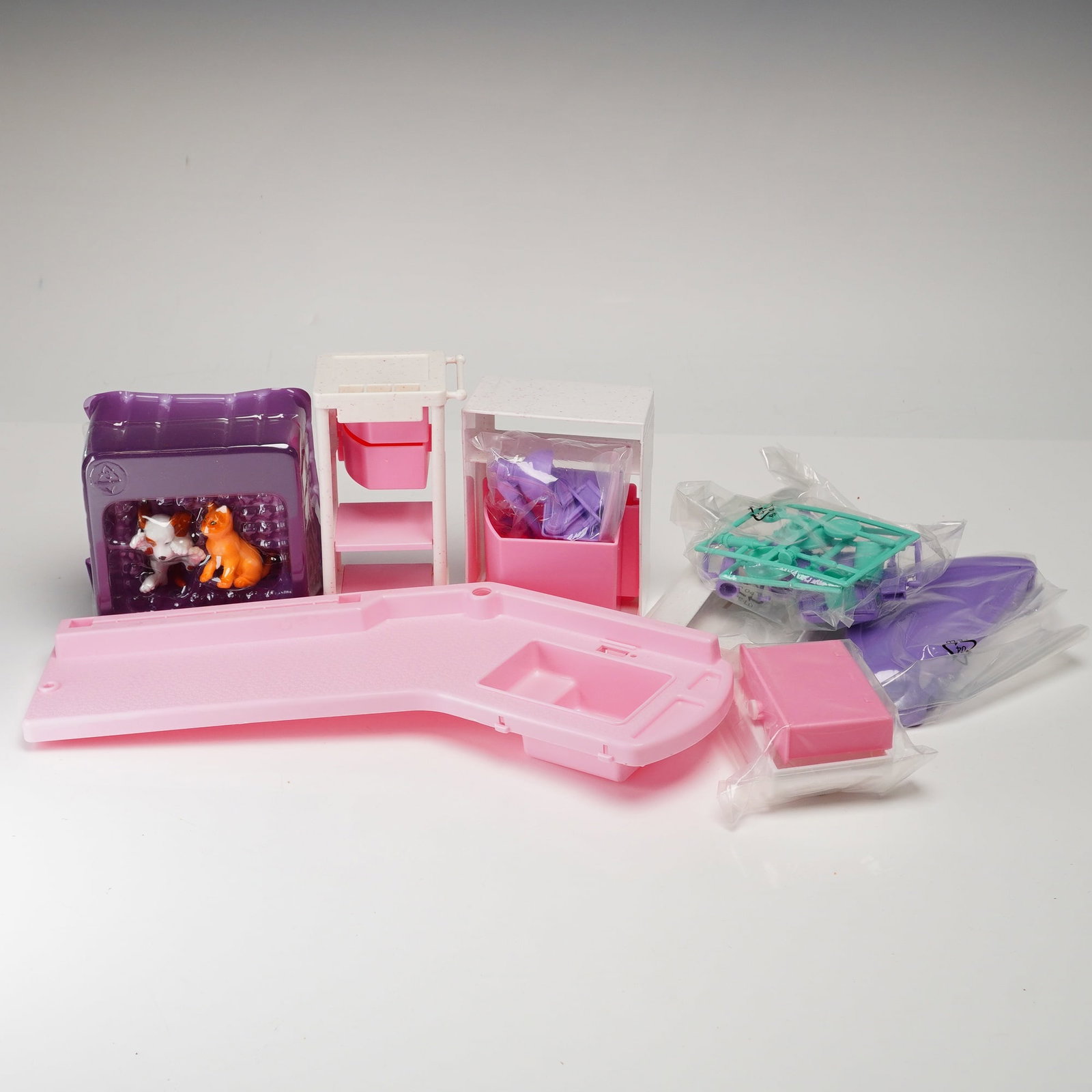 Mattel Barbie Vet Center Playset: This Barbie Vet Center playset is manufactured by Mattel and primarily constructed of molded plastic in signature shades of pink, white, and purple. Produced circa 2001, this 1:6 scale accessory set i