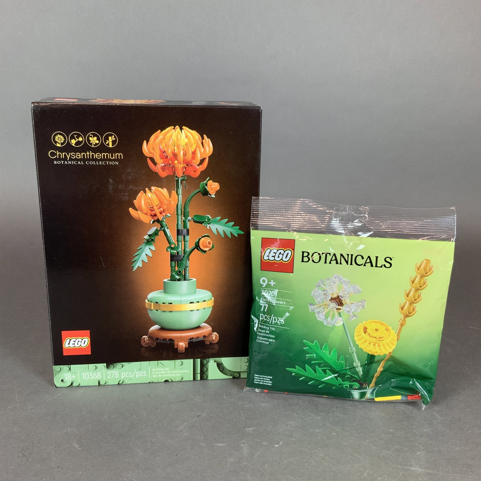 2pc LEGO Botanical Sets, Chrysanthemum 10368 and Field Flowers 30701: This lot consists of two factory-sealed LEGO building sets from the Botanical Collection. The first item is LEGO Icons set 10368, the Chrysanthemum. It contains 278 plastic pieces and is intended for 
