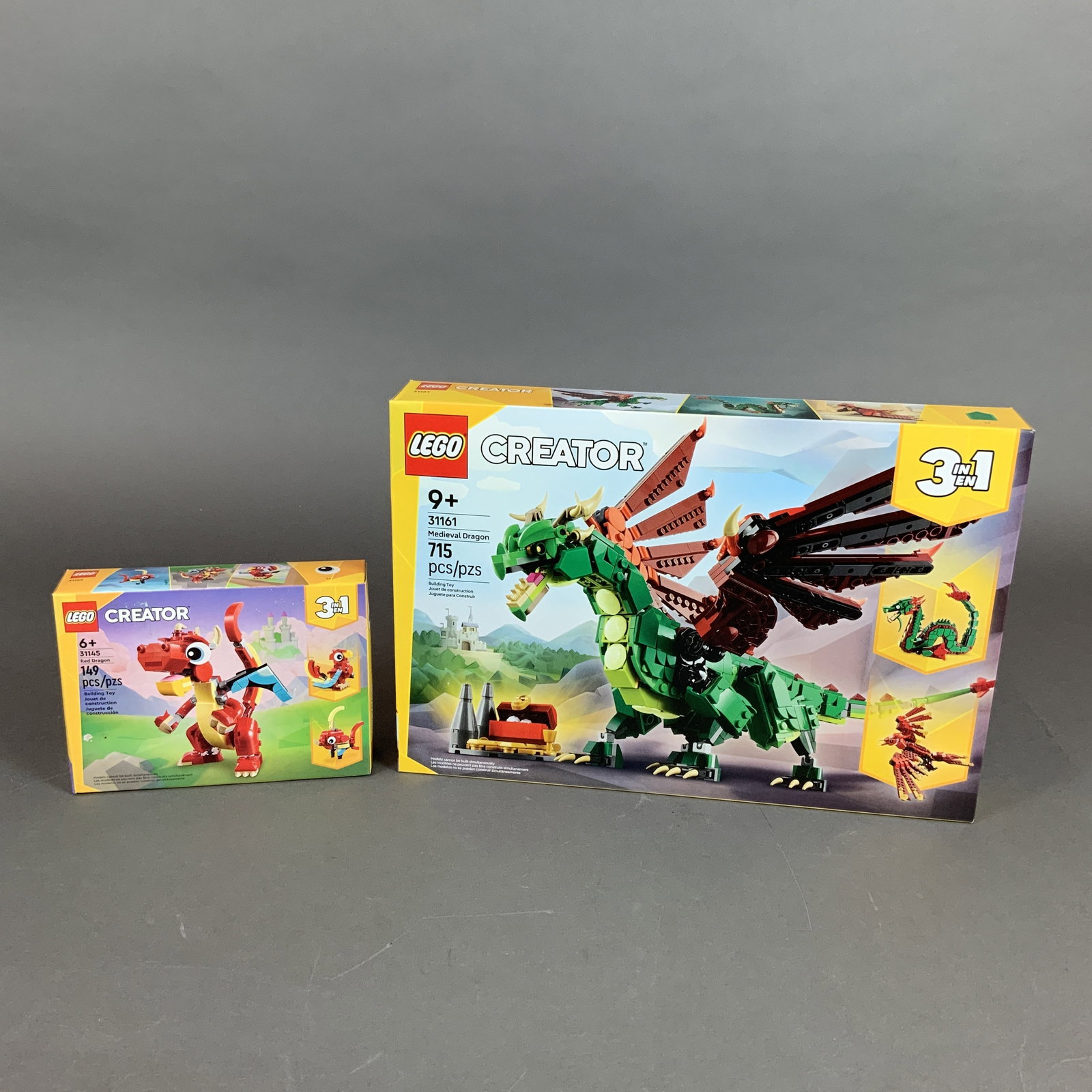 2pc LEGO Creator 3-in-1 Sets, Medieval Dragon 31161 and Red Dragon 31145: This lot consists of two LEGO Creator 3-in-1 construction sets made of molded plastic. The first set is the Medieval Dragon, set number 31161, containing 715 pieces with an age recommendation of 9+. T