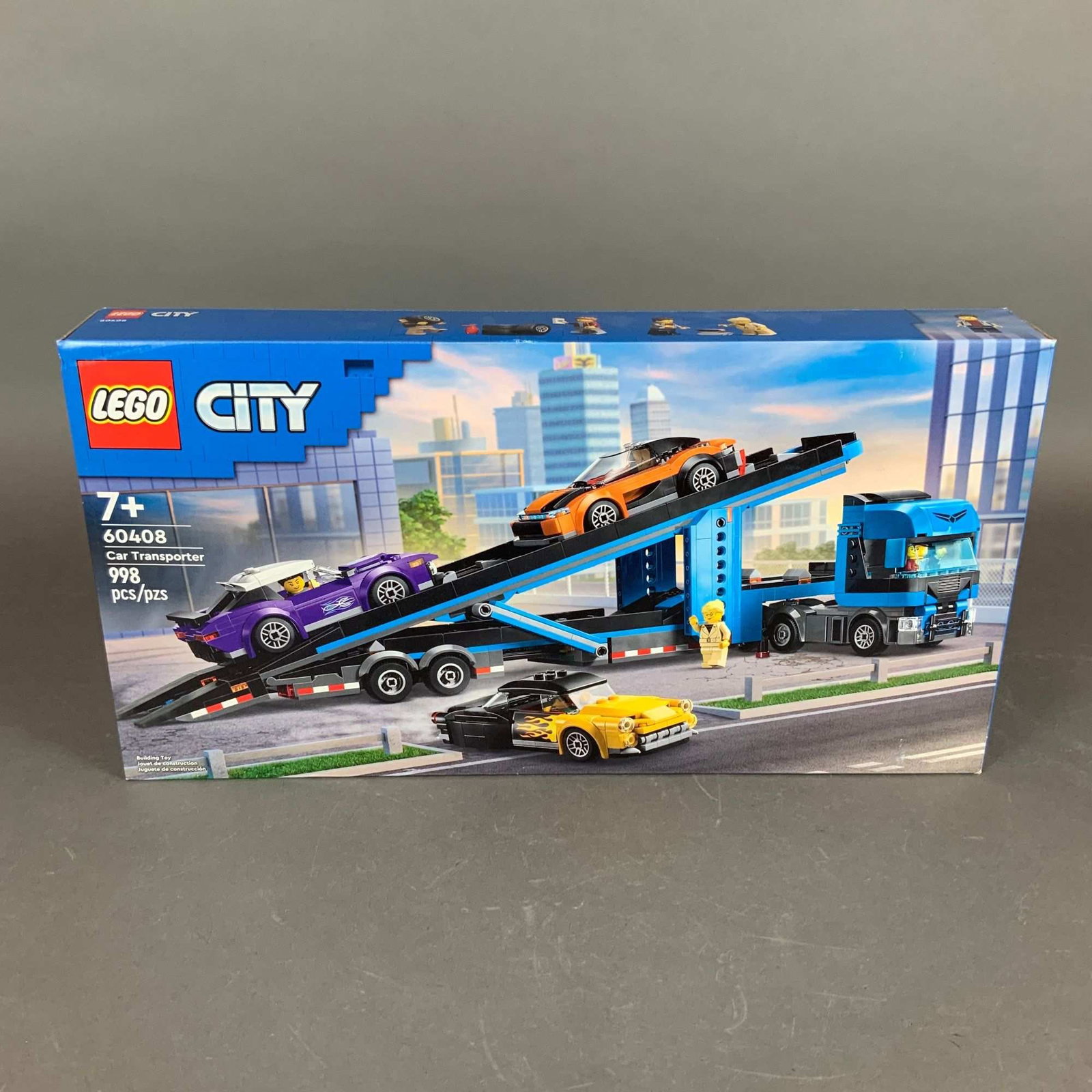 LEGO City Car Transporter Truck with Sports Cars Building Set: This is a LEGO City theme construction set, model number 60408, titled Car Transporter Truck with Sports Cars. The set consists of 998 plastic pieces and is designed for ages 7 and up. The primary bui