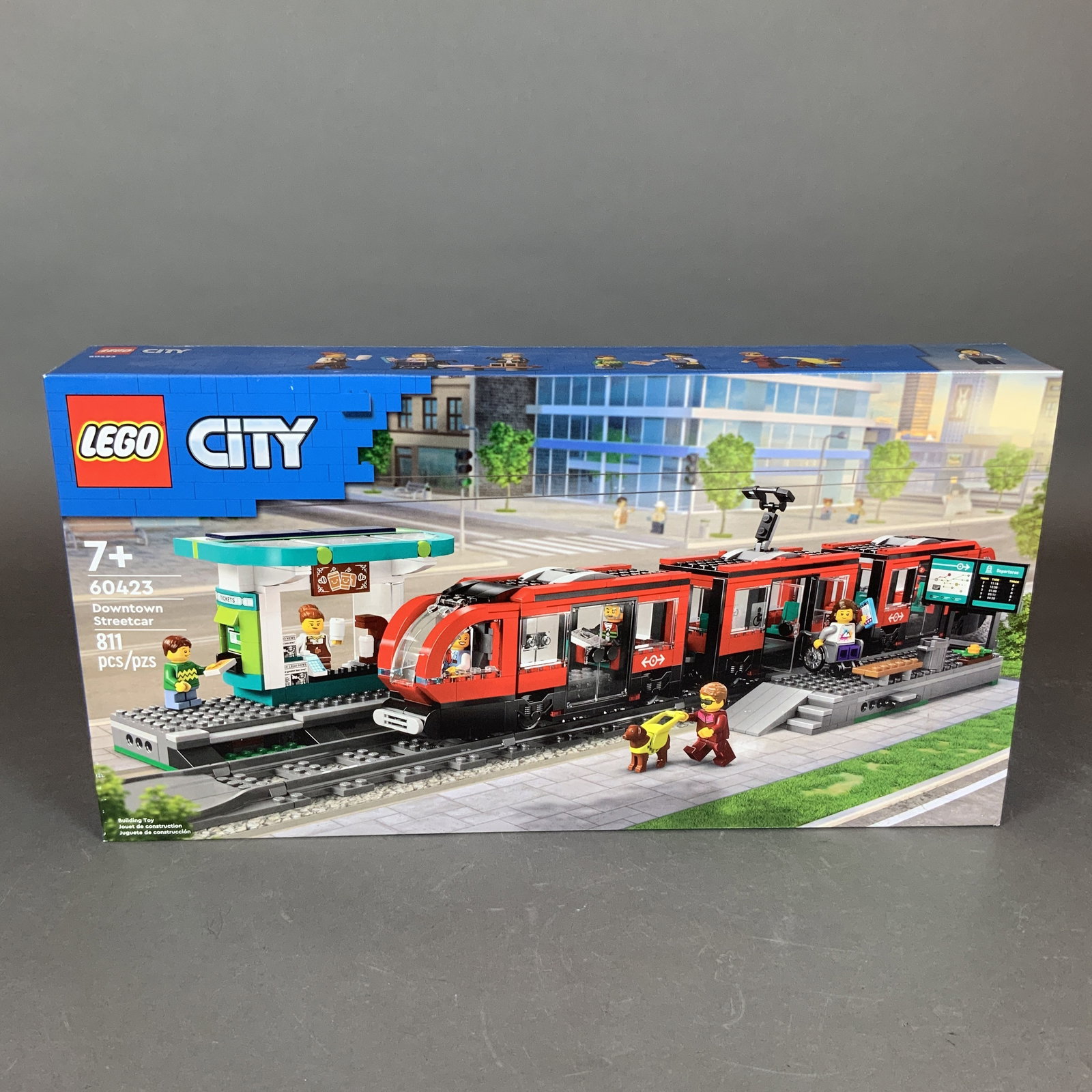 LEGO City Set, Downtown Streetcar 60423: This LEGO City building set, titled Downtown Streetcar, carries the set number 60423. It consists of 811 interlocking plastic pieces designed for builders aged 7 and up. The set features a modern red 