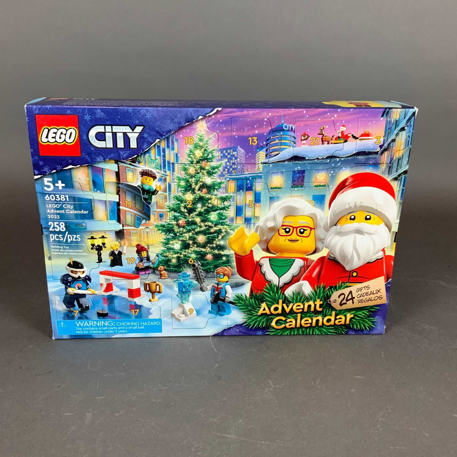 LEGO Set, City Advent Calendar 2023 60381: This LEGO City Advent Calendar, set number 60381, is a 2023 holiday countdown construction toy. The set consists of plastic building pieces housed within a cardboard retail box designed with 24 perfor