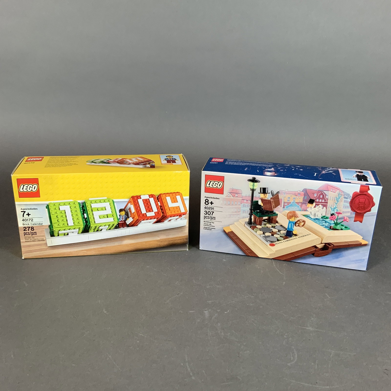 Two LEGO Building Sets including Iconic Brick Calendar 40172 and Hans Christian Andersen Creative: Two LEGO building sets in original retail boxes. The first item is the LEGO Iconic Brick Calendar, set number 40172, which contains 278 plastic pieces. This set features a functional desk calendar des