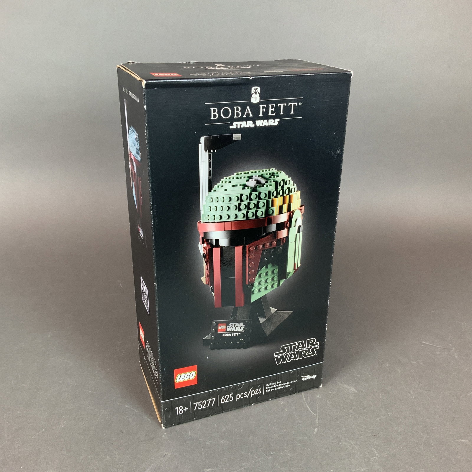 LEGO Star Wars Set, Boba Fett 75277: This LEGO Star Wars building set features the Boba Fett Helmet from the Star Wars Helmet Collection. Manufactured by LEGO, the set is numbered 75277 and contains 625 plastic construction pieces. It is