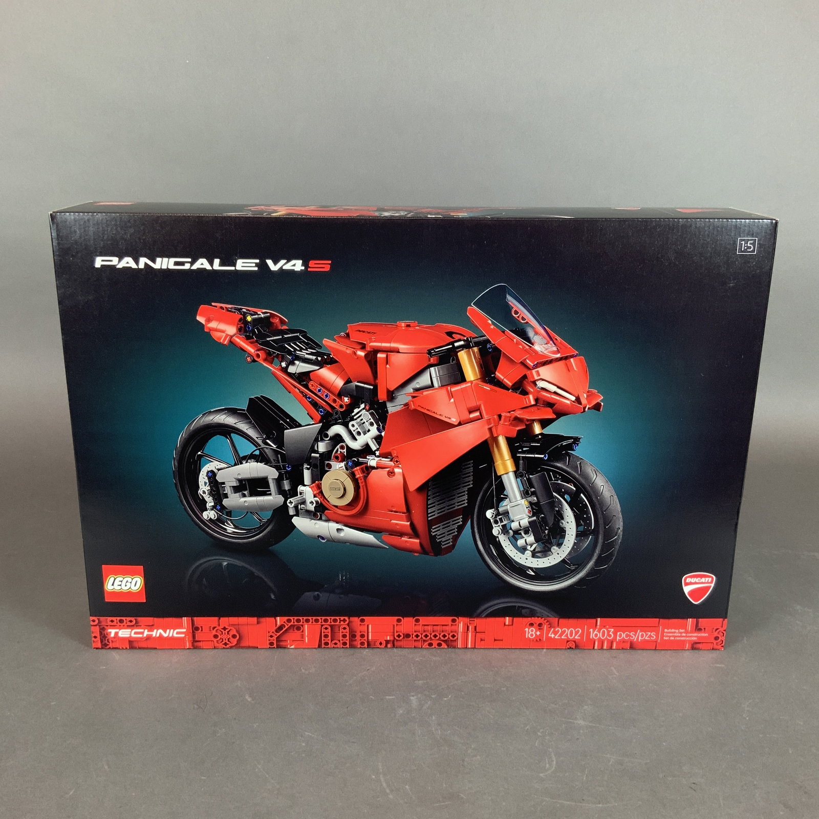 LEGO Technic Ducati Panigale V4 S Motorcycle Model Kit 42202: This LEGO Technic construction set features the Ducati Panigale V4 S motorcycle, set number 42202. The model is designed at a 1:5 scale and is comprised of 1603 plastic pieces. The set includes severa