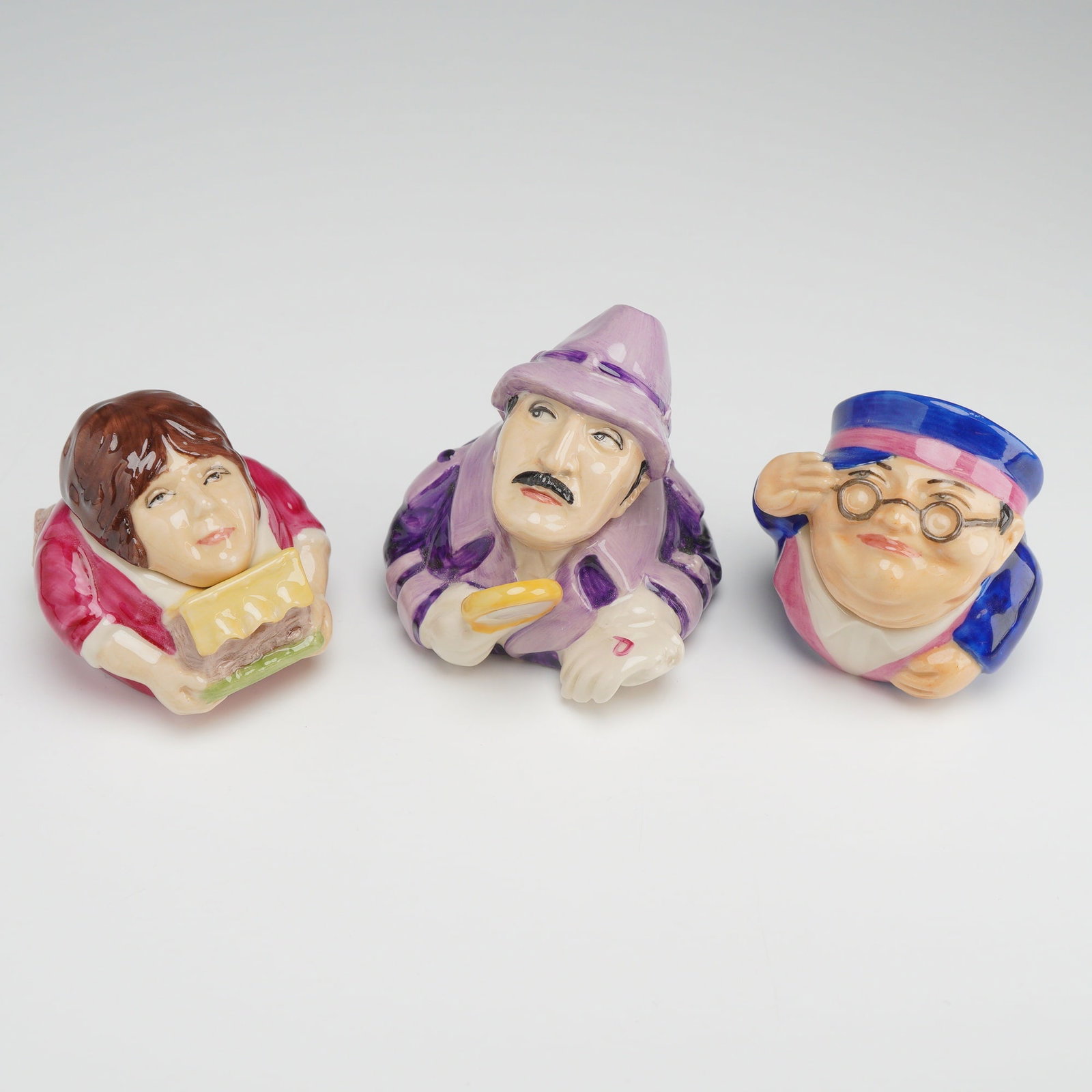 3pc Kevin Francis Face Pots, Dave Winter, Benny Hill, and Inspector Clusoe: This set consists of three contemporary ceramic trinket pots, known as Face Pots, manufactured by Kevin Francis. Each pot is a two-part construction featuring a removable lid that forms the head and a