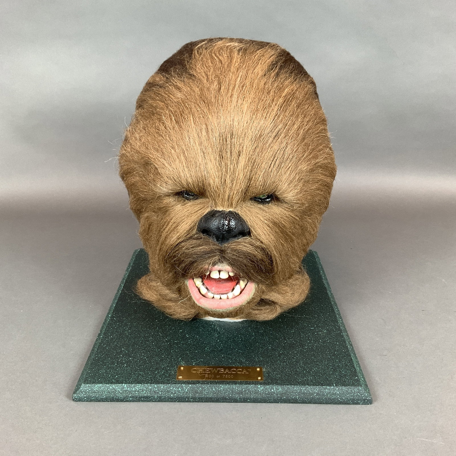 Large Star Wars Chewbacca Limited Edition 1:1 Scale Lifelike Bust by Illusive Originals, 900 of: This large Chewbacca head is a 1:1 scale, lifelike prop replica bust of the Wookiee character from the Star Wars film franchise, produced by Illusive Originals and licensed by Lucasfilm Ltd. This piec