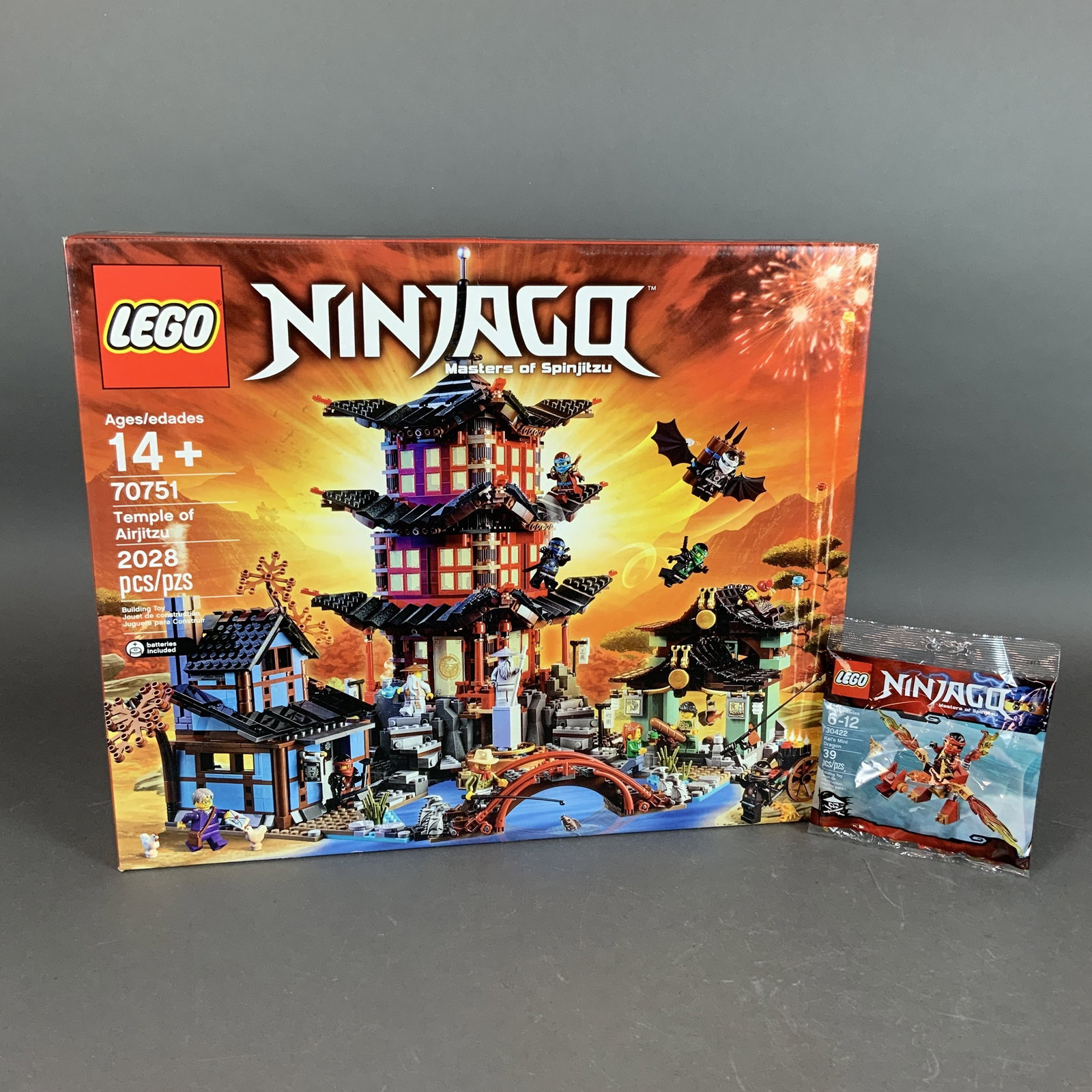 Two LEGO Ninjago Sets Including Temple of Airjitzu 70751 and Kai's Mini Dragon 30422: This lot features two LEGO items from the Ninjago: Masters of Spinjitzu theme. The primary item is the Temple of Airjitzu, set number 70751. This large-scale construction set contains 2028 plastic pie