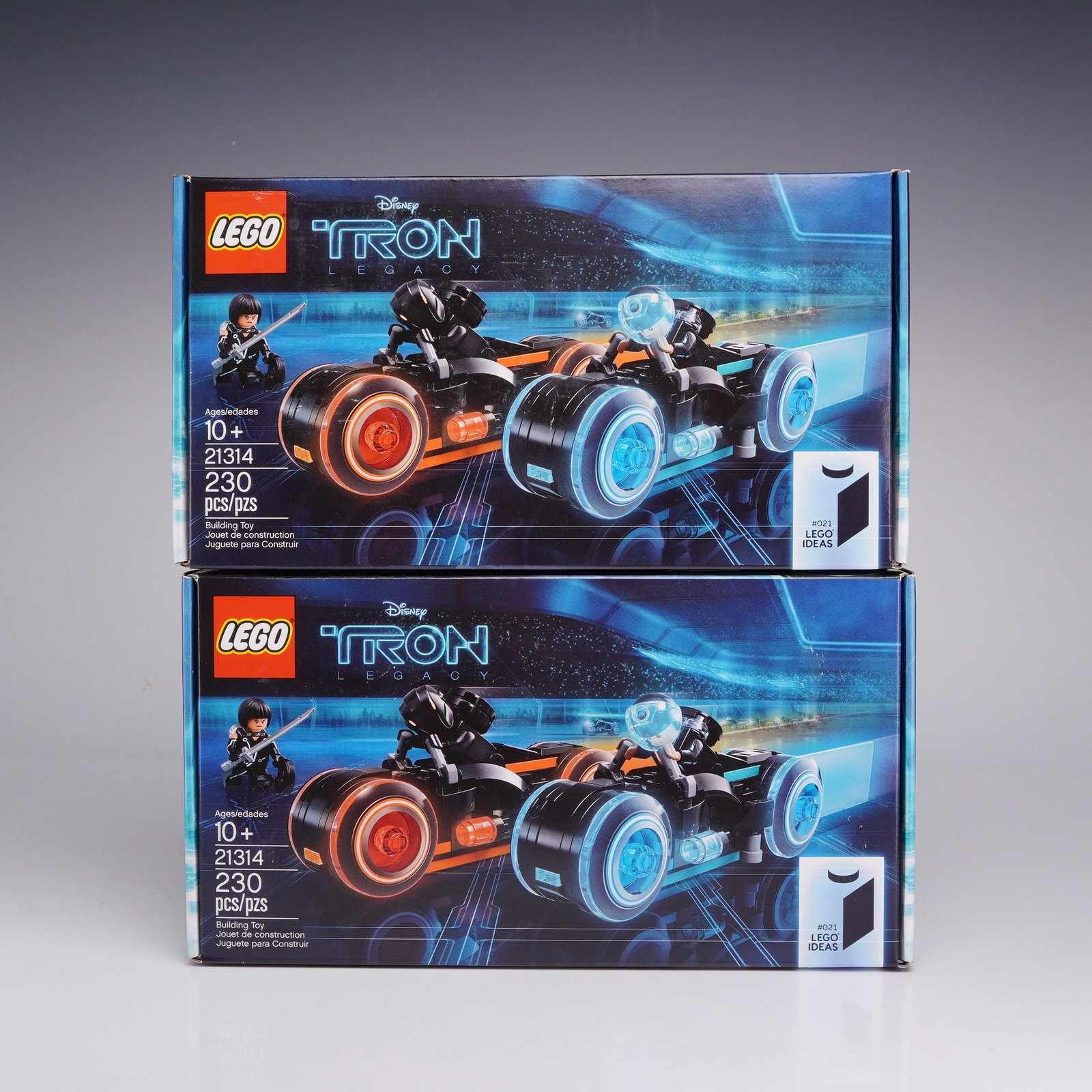 2pc LEGO Ideas 21314 TRON: Legacy Construction Toy Sets: This lot consists of two LEGO construction toy sets from the Ideas product line, set number 21314, based on the Disney film TRON: Legacy. Each set contains 230 plastic pieces used to assemble two ligh