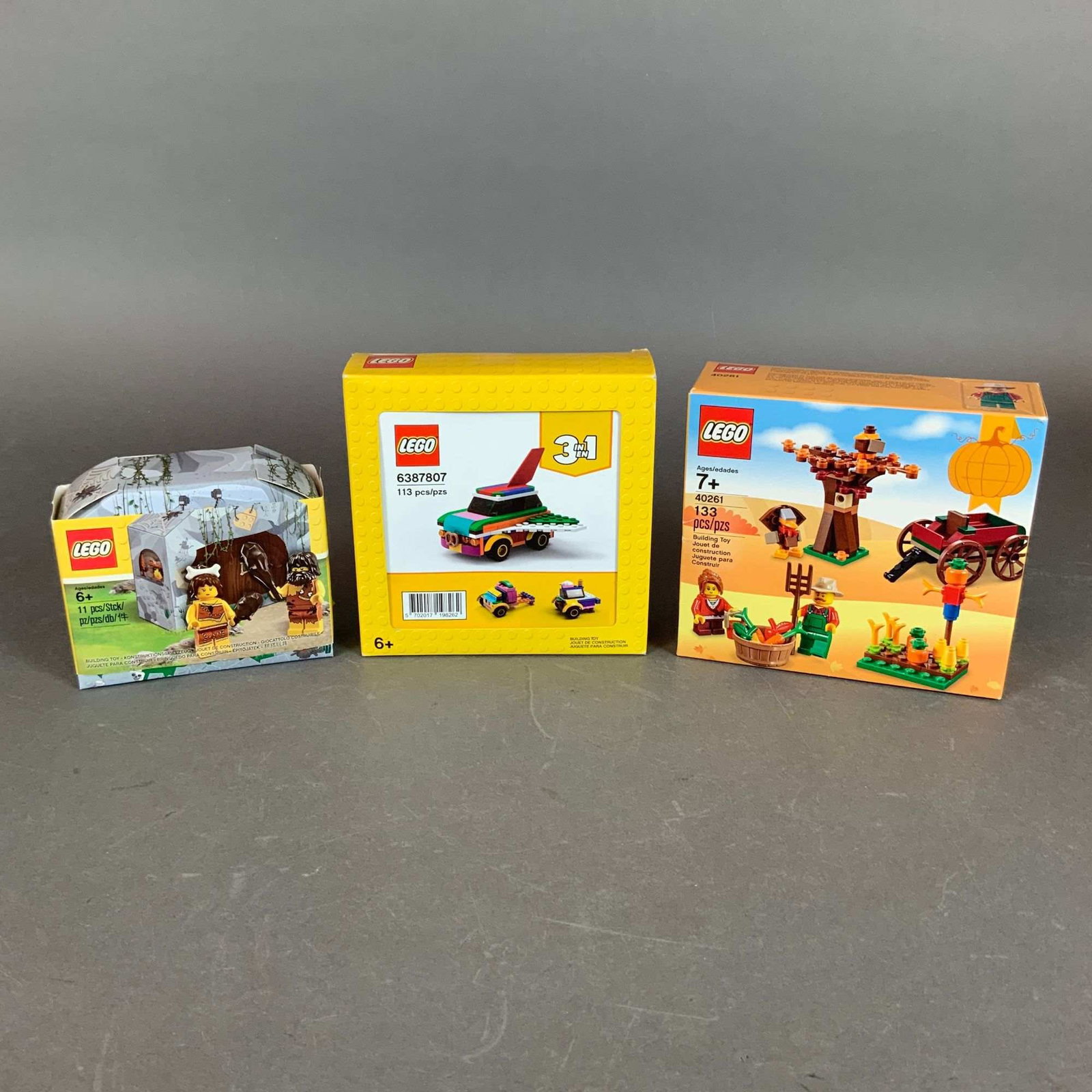 3pc LEGO Building Sets, Thanksgiving Harvest, Creator, and Caveman: A trio of building sets manufactured by the LEGO Group, comprised of molded plastic interlocking construction bricks. This collection includes three distinct themes in their original packaging: LEGO T