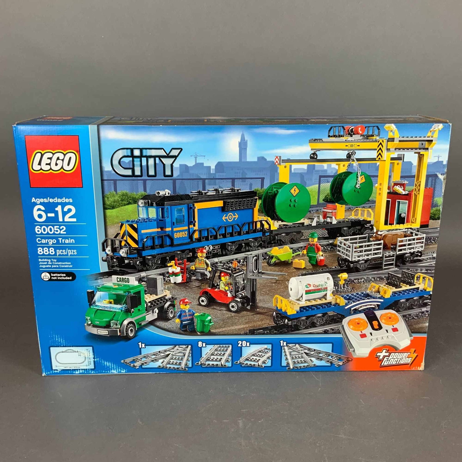 LEGO City Cargo Train Building Set 60052: This is a LEGO City Cargo Train building set, identified as set number 60052. The set contains 888 plastic pieces and is designed for ages 6 to 12. It features a motorized locomotive powered by LEGO P