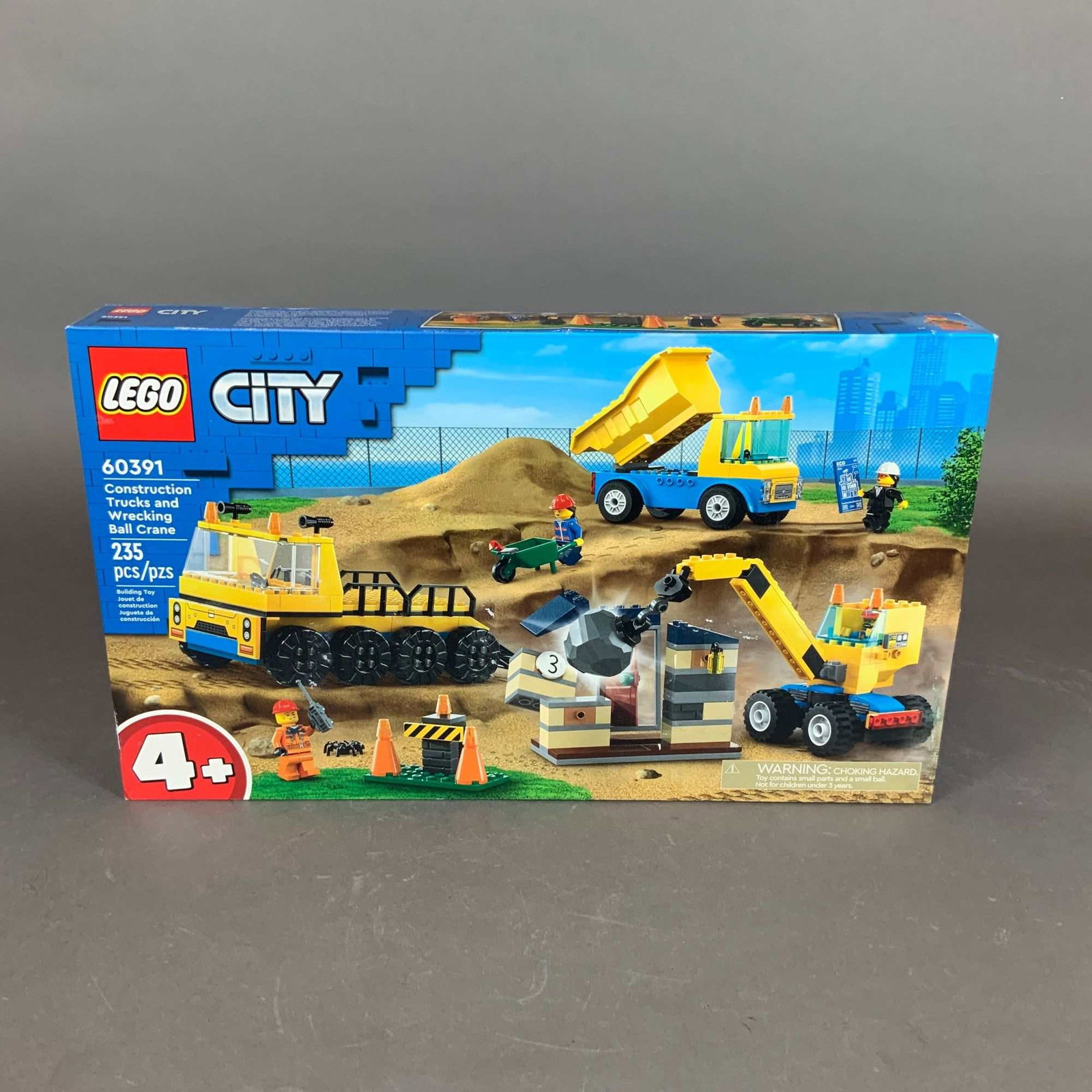LEGO City Construction Trucks and Wrecking Ball Crane Building Set 60391: This is a factory-sealed LEGO City construction-themed building set, model number 60391, titled Construction Trucks and Wrecking Ball Crane. The set contains 235 plastic pieces and is part of the Lear