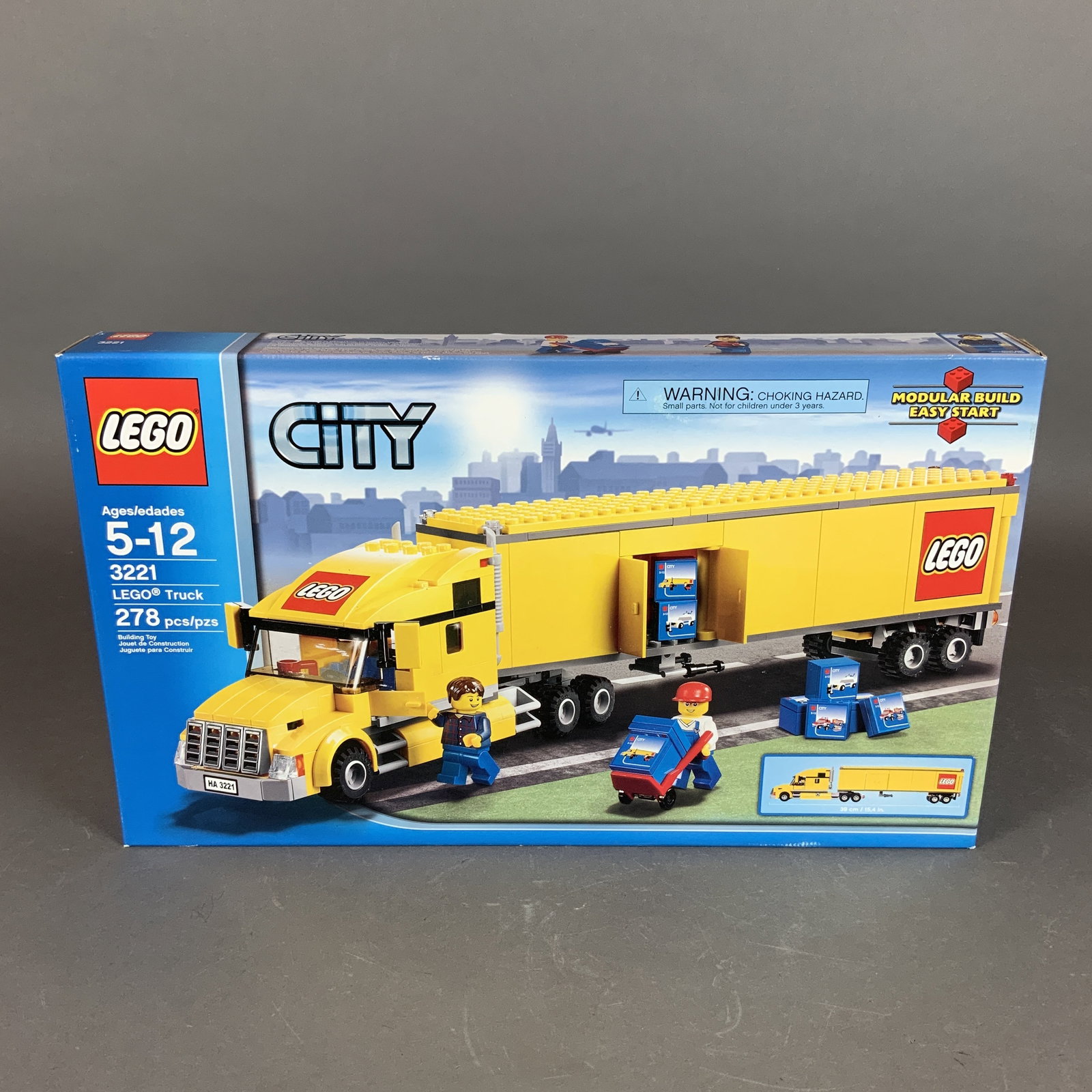 LEGO City Truck Set 3221: This lot features LEGO City set number 3221, titled LEGO Truck. This set is made of plastic components and contains 278 pieces. The set builds a yellow semi-truck and trailer featuring the LEGO compan