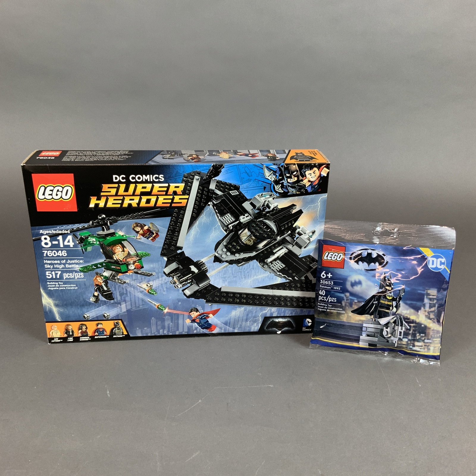 Two LEGO DC Super Heroes Building Toy Sets 76046 and 30653: This lot features two LEGO DC Super Heroes building toy sets. The primary item is LEGO set 76046, Heroes of Justice: Sky High Battle, inspired by the film Batman v Superman: Dawn of Justice. This set 