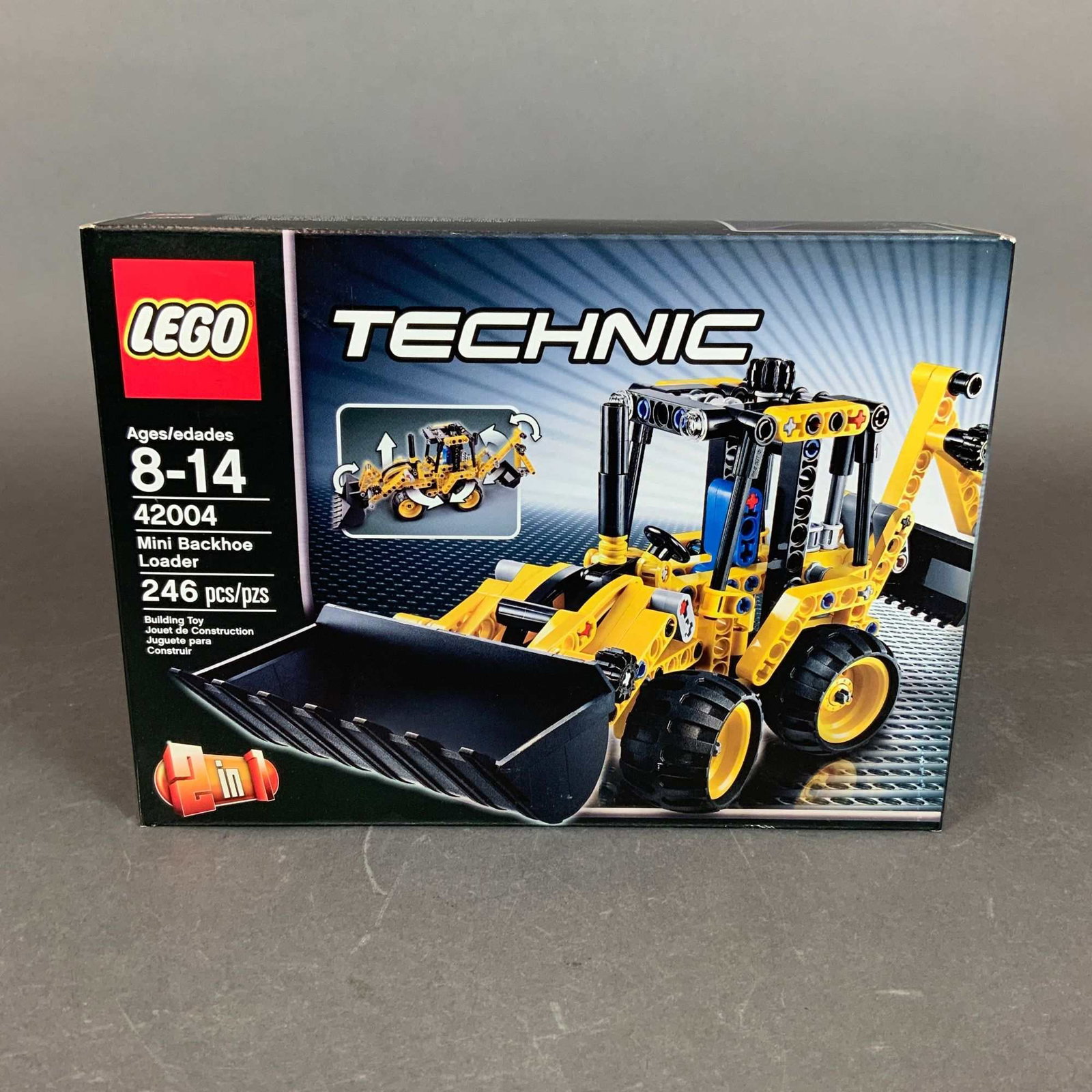 LEGO Technic Set, Mini Backhoe Loader or Telehandler 42004: This is a LEGO Technic building set, model number 42004, identified as the Mini Backhoe Loader. Produced by The LEGO Group, this 2-in-1 set contains 246 plastic pieces and is designed for ages 8 to 14