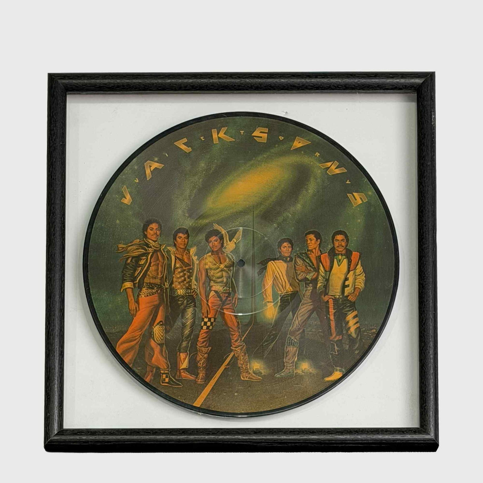 The Jacksons Victory Framed 12-Inch Vinyl Picture Disc LP: This item is a framed 12-inch vinyl picture disc for the 1984 album Victory by The Jacksons, a group also known as the Jackson 5. The disc features original artwork by Michael Whelan. The front side d