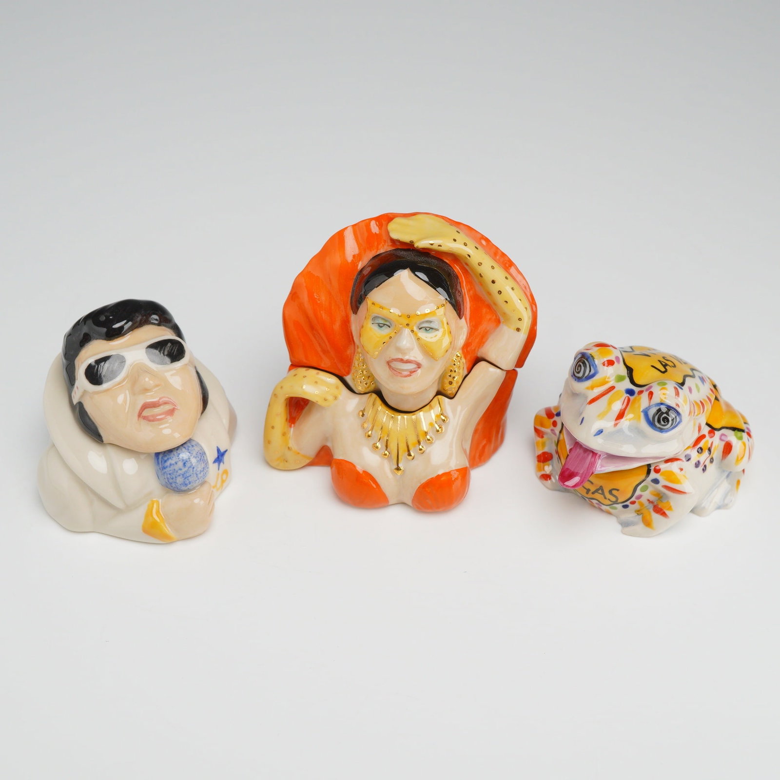 3pc Kevin Francis Face Pots, Including Signed Prototype Elvis: A collection of three themed ceramic Face Pots produced by Kevin Francis Ceramics, featuring subjects related to Las Vegas. Each pot is a two-piece collectible consisting of a separate lid and base. T