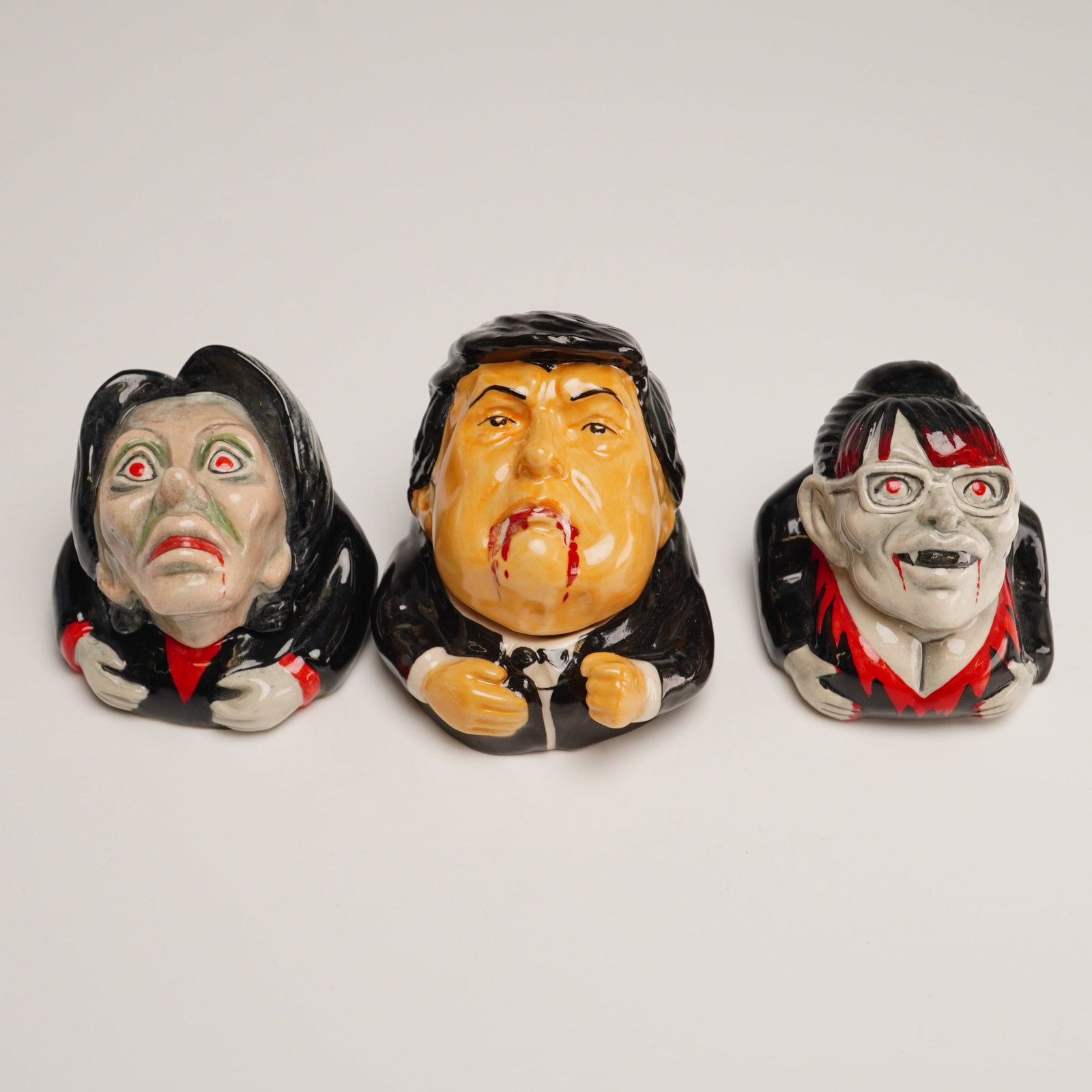 3pc Kevin Francis Satirical Vampire Political Face Pots, Trump, Palin, Pelosi: A trio of satirical ceramic lidded Face Pots by Kevin Francis Ceramics, featuring three United States political figures depicted as vampires. The set includes Donald Trump, Nancy Pelosi, and Sarah Pal