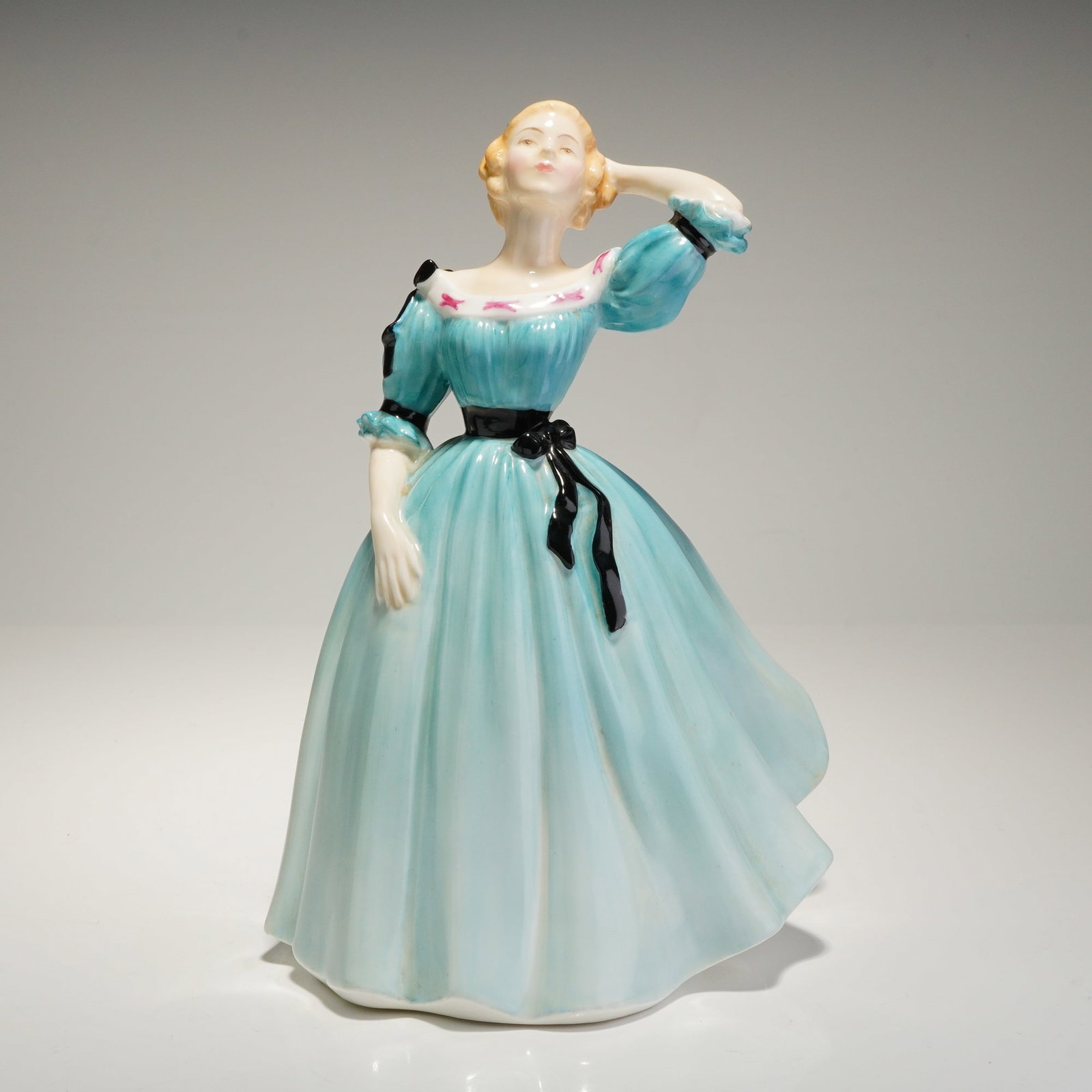 Royal Doulton Figurine Celeste HN2237: A bone china figurine titled "Celeste," model number HN 2237, manufactured by Royal Doulton. The figure depicts a standing woman in a voluminous dress, finished in a glossy aqua blue glaze. The dress 