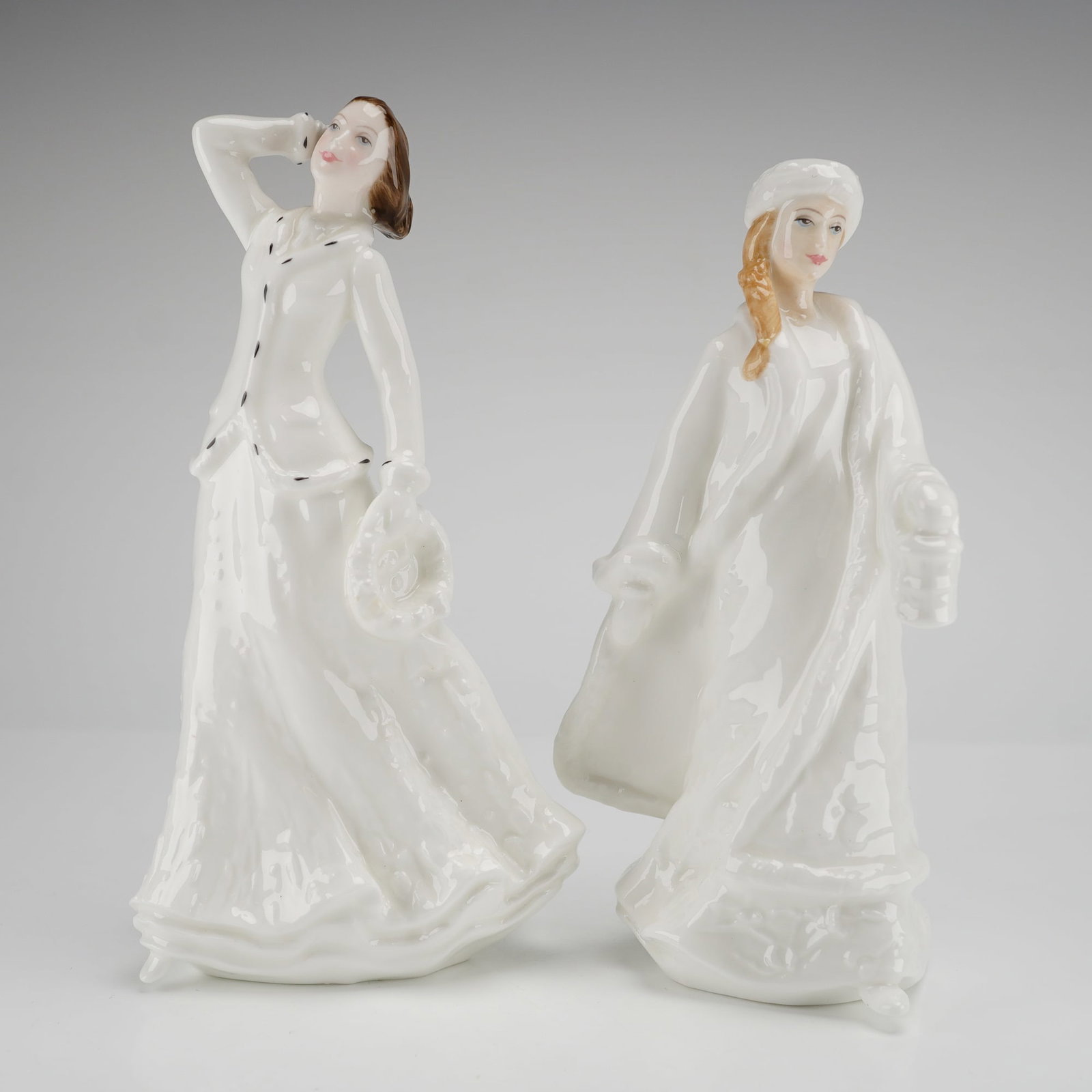 A Pair of Royal Doulton Christmas Figurines HN4067 HN3953: A pair of Royal Doulton bone china figurines, confirmed as Christmas Garland HN4067 and Christmas Lantern HN3953, marked A Mark Lincoln and dated 1999. Dimensions: 3.00"L x 2.50"W x 6.00"H Weight: 12.