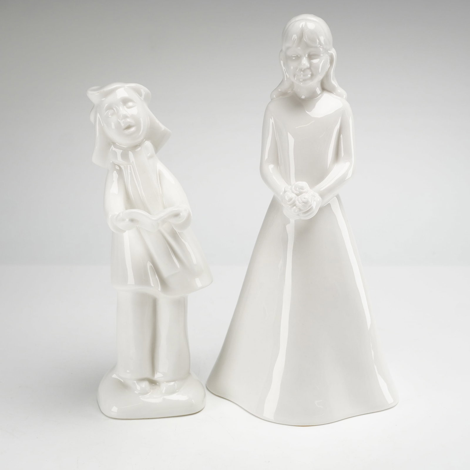 2pc Royal Doulton and Coalport Figurines: Two white glazed figurines. The first is a Royal Doulton porcelain figurine from the Images collection titled Christmas Choir Carol Singer-Sister, model HN 4291. This piece is a limited edition number