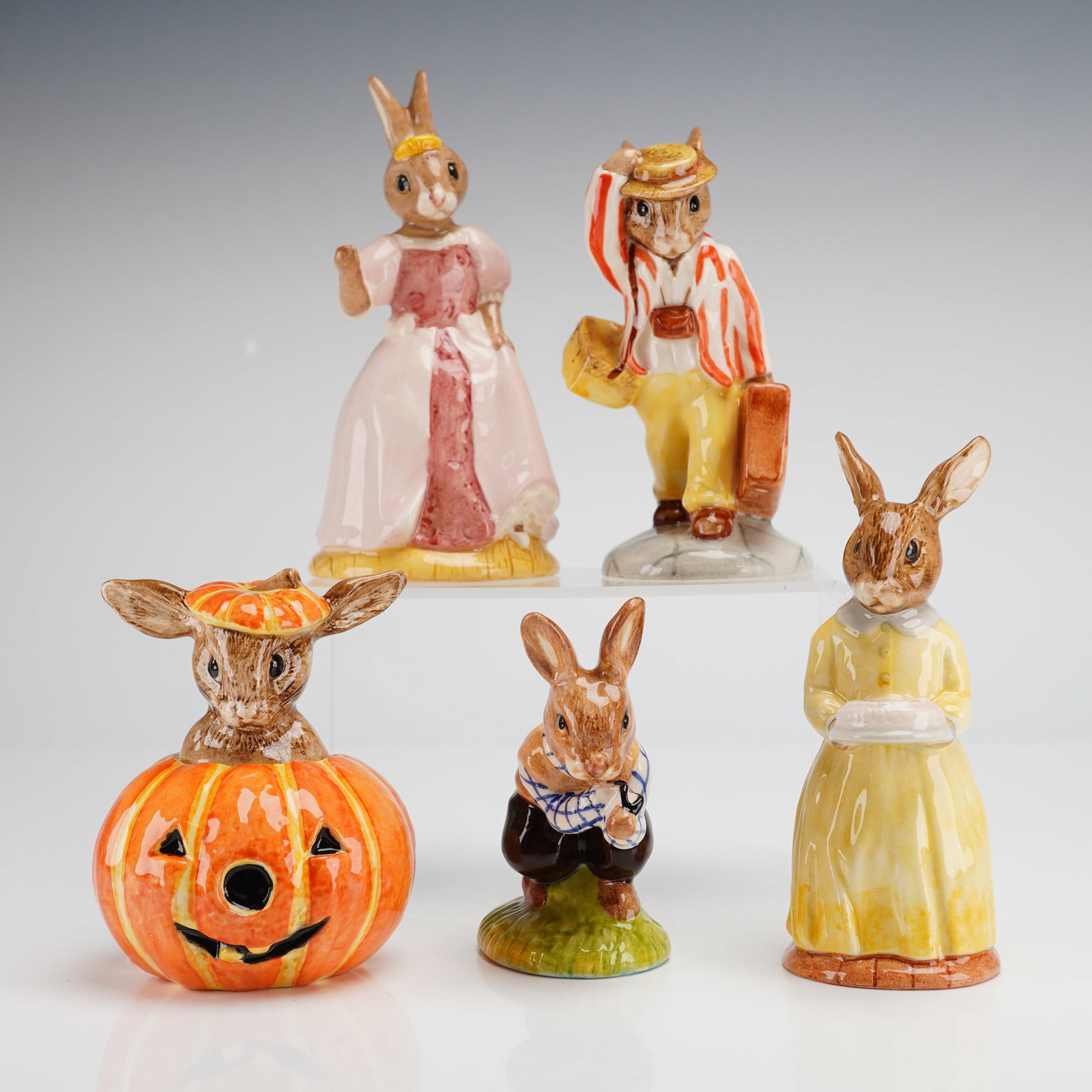 5pc Royal Doulton Bunnykins Figurines: A group of five Royal Doulton Bunnykins ceramic figurines. The collection includes Tom DB72, Father DB154, Halloween D132, Cinderella DB231, and the 60th Anniversary DB137. Each figurine is hand-made 