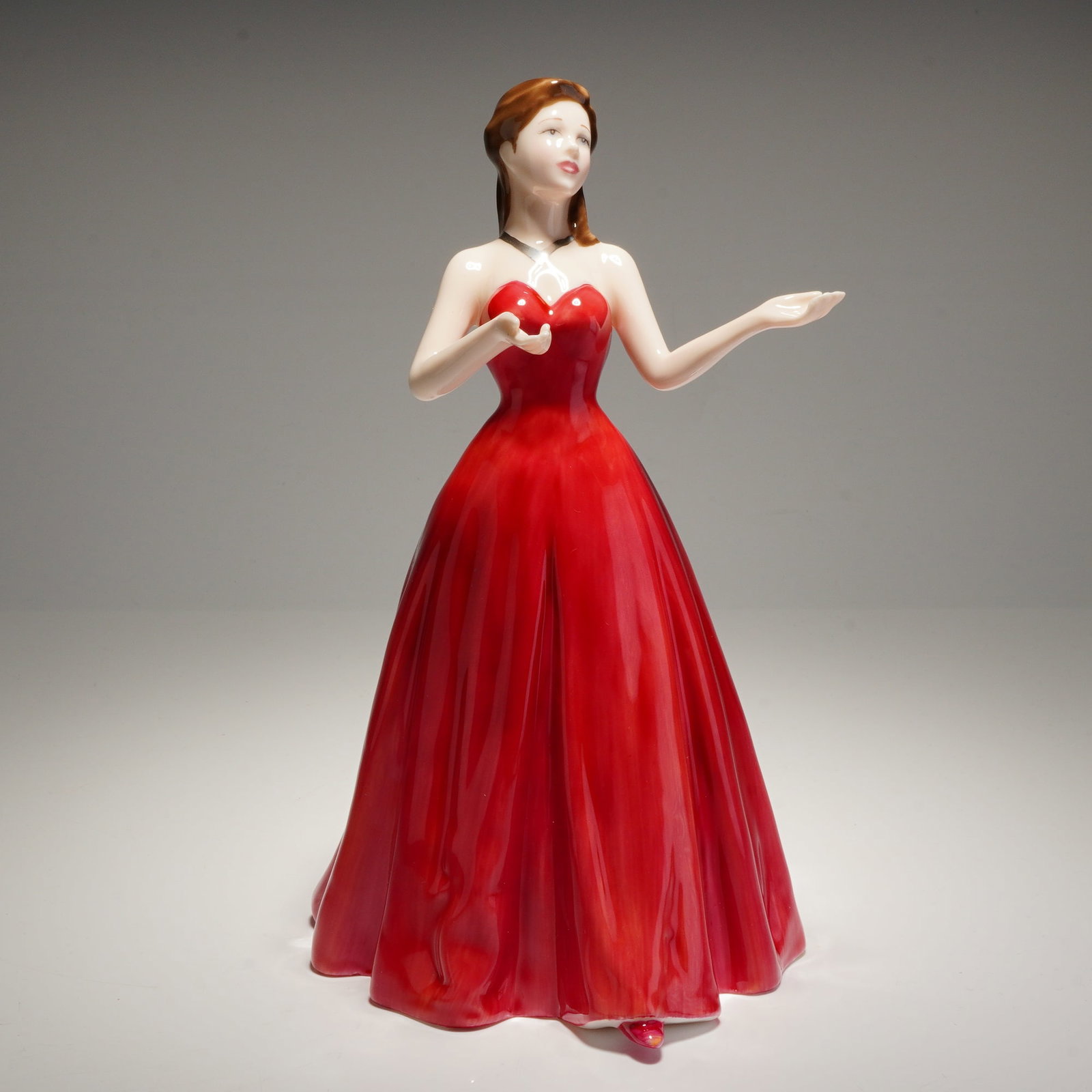 Royal Doulton My Love HN4392 Figurine: A Royal Doulton My Love HN4392 bone china figurine, modeled by Nada M. Pedley. This hand-made and hand-decorated piece depicts a woman with brown hair styled in a half-updo, wearing a strapless, floor
