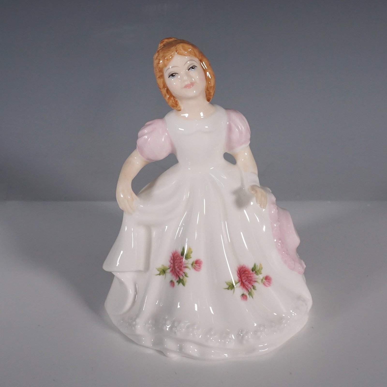 Royal Doulton, Figure of the Month, November, HN3328: This exquisite Royal Doulton figurine, Figure of the Month, November (HN 3328), was introduced in 1990 as part of the collectible Figure of the Month series. Designed by Robert Tabbenor, the figurine 