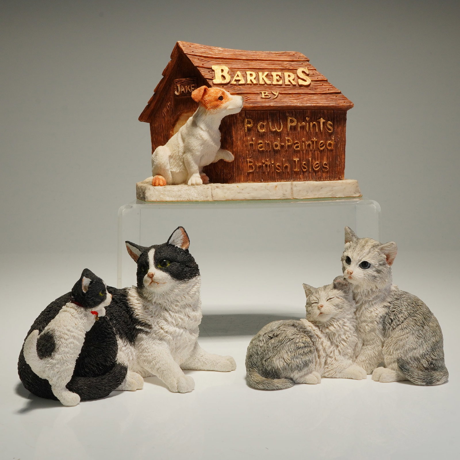 3pc Barkers and Country Artists Resin Cat and Dog Figurines: A collection of three hand-painted resin cat and dog figurines from Barkers and Country Artists. The set includes a Barkers by Paw Prints doghouse figurine titled Jake, marked "Hand-Painted British Is