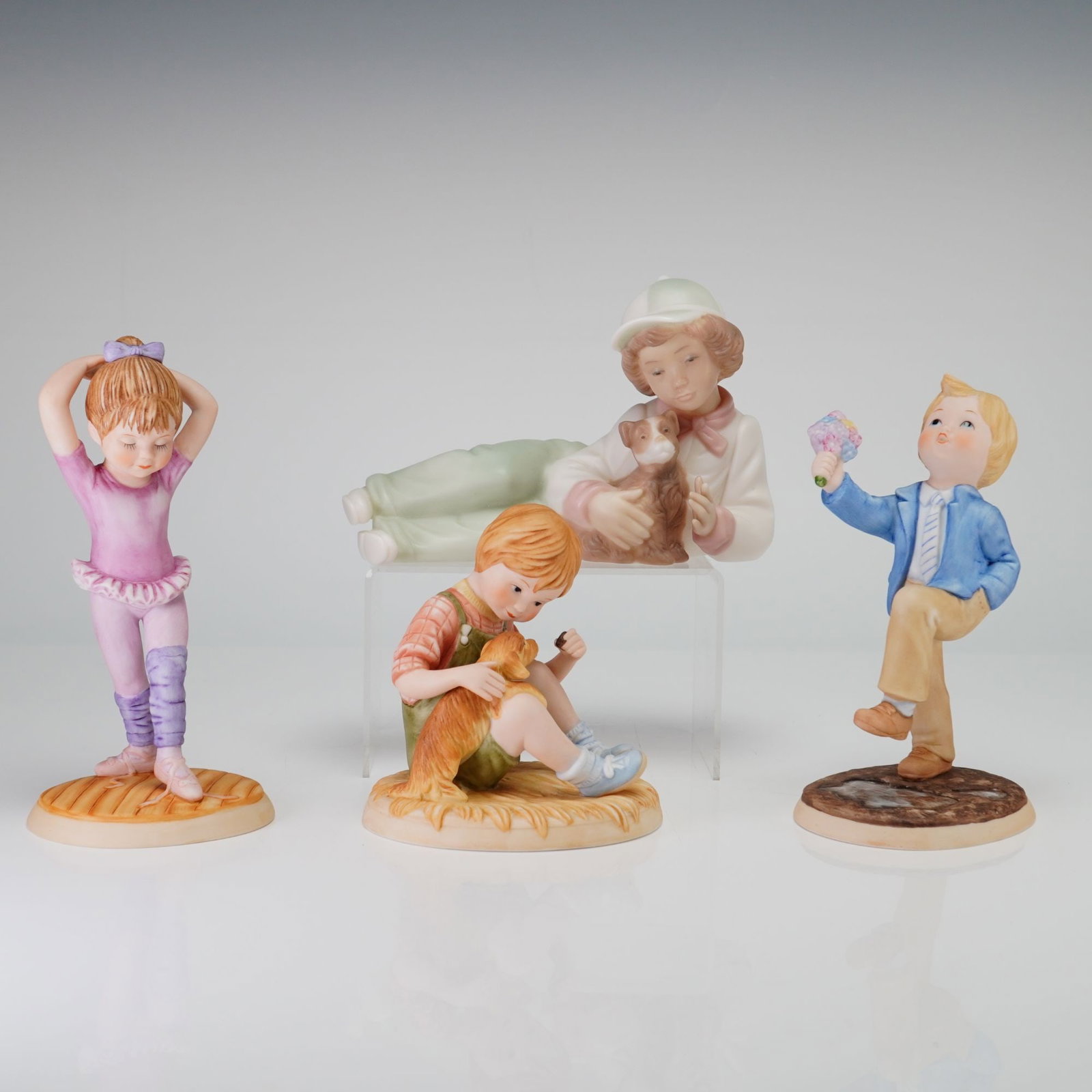 4pc Lenox Days of the Week and Golden Memories Porcelain Figurines: This collection consists of four porcelain figurines featuring childhood subjects: three from the Lenox Days of the Week Fine Porcelain Collection and one from Golden Memories. The Lenox pieces includ